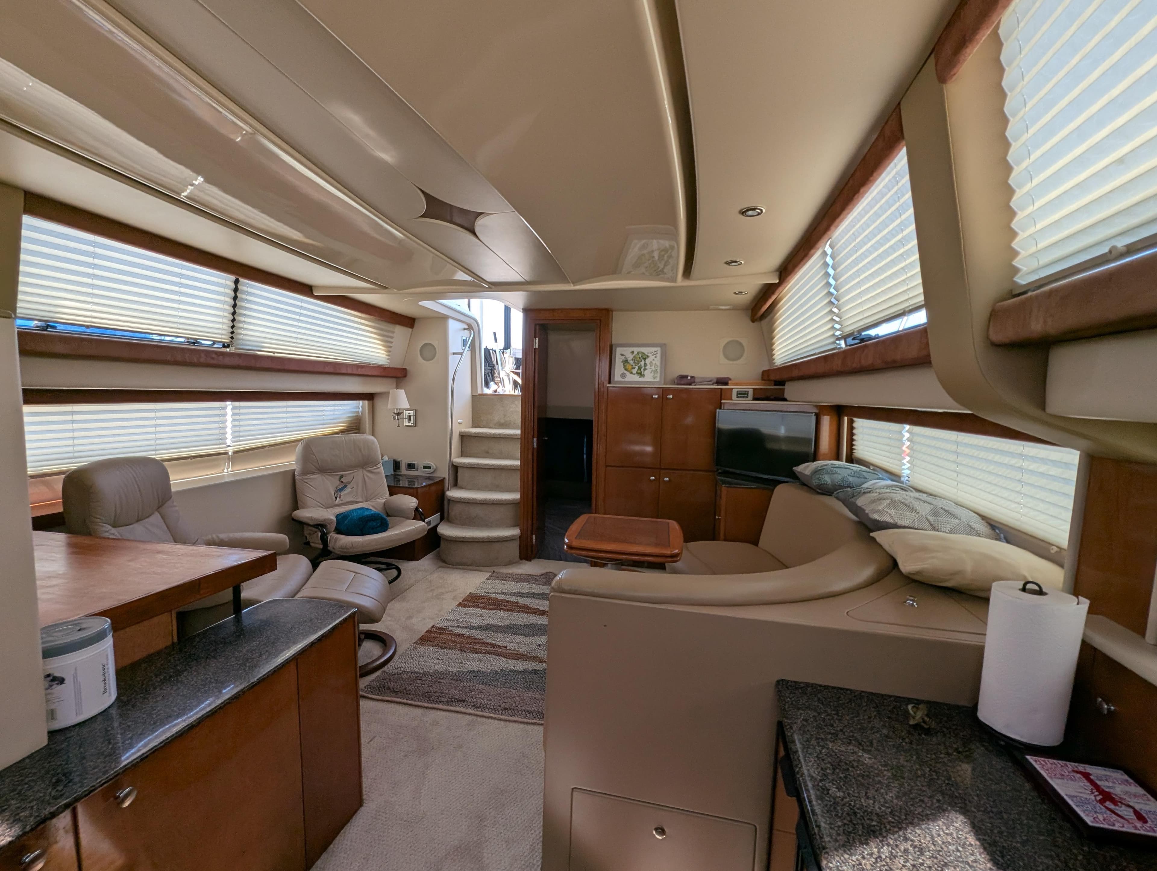 Luxurious interior of a 2006 Meridian 368 yacht with modern furnishings and ample natural light.