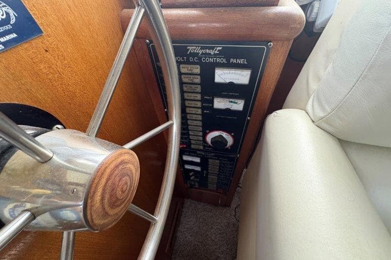 1987 Tollycraft 34 Sundeck Motor Yacht helm with DC control panel and steering wheel.