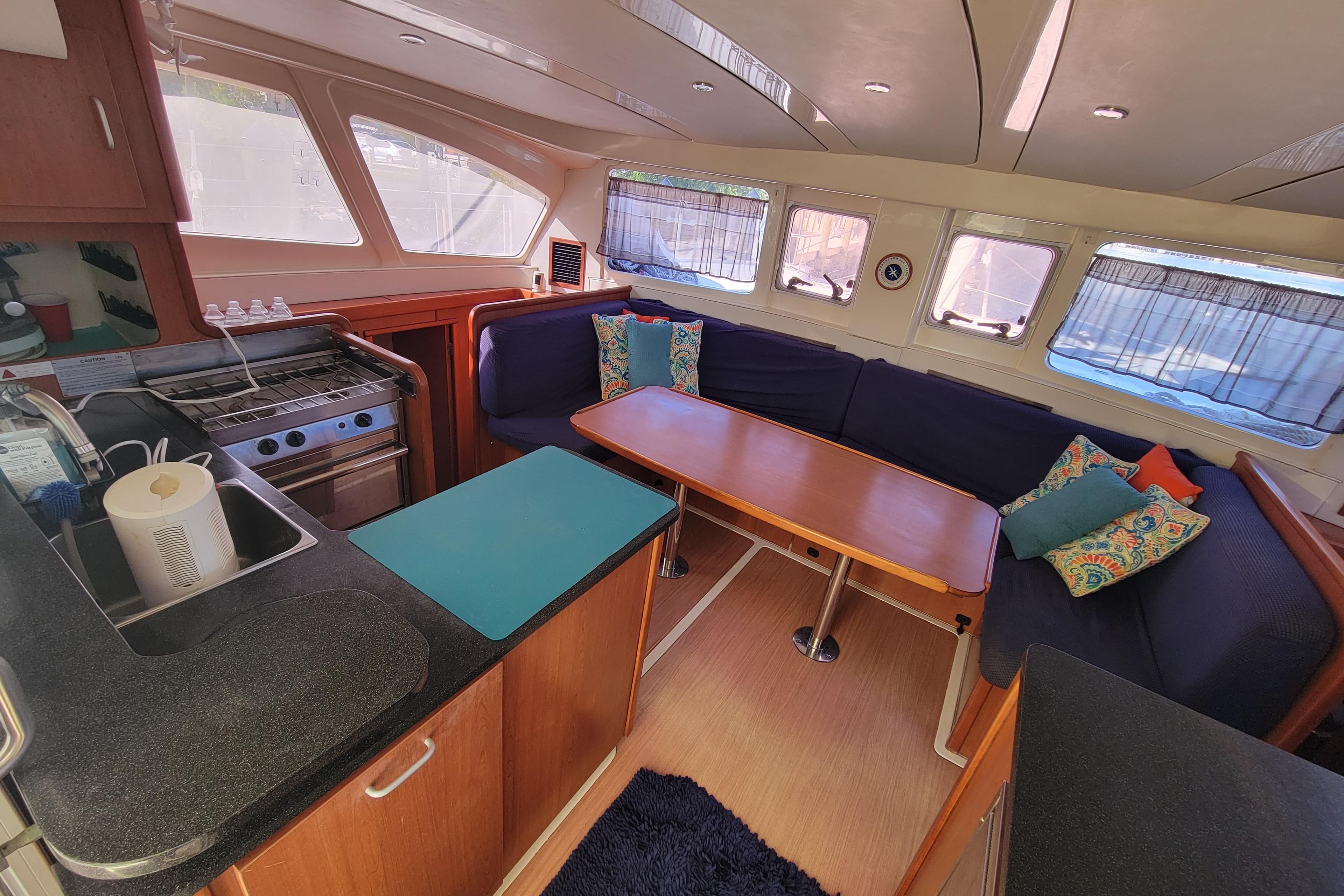 Interior of 2014 Leopard 39 catamaran with kitchen and cozy seating area.