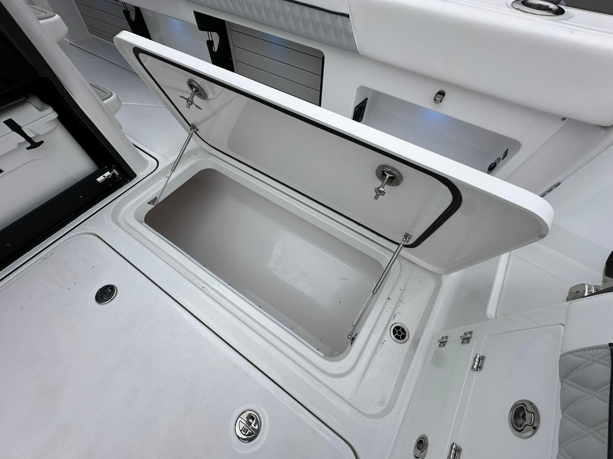 Open storage compartment on a 2024 Blackfin 400 CC boat.
