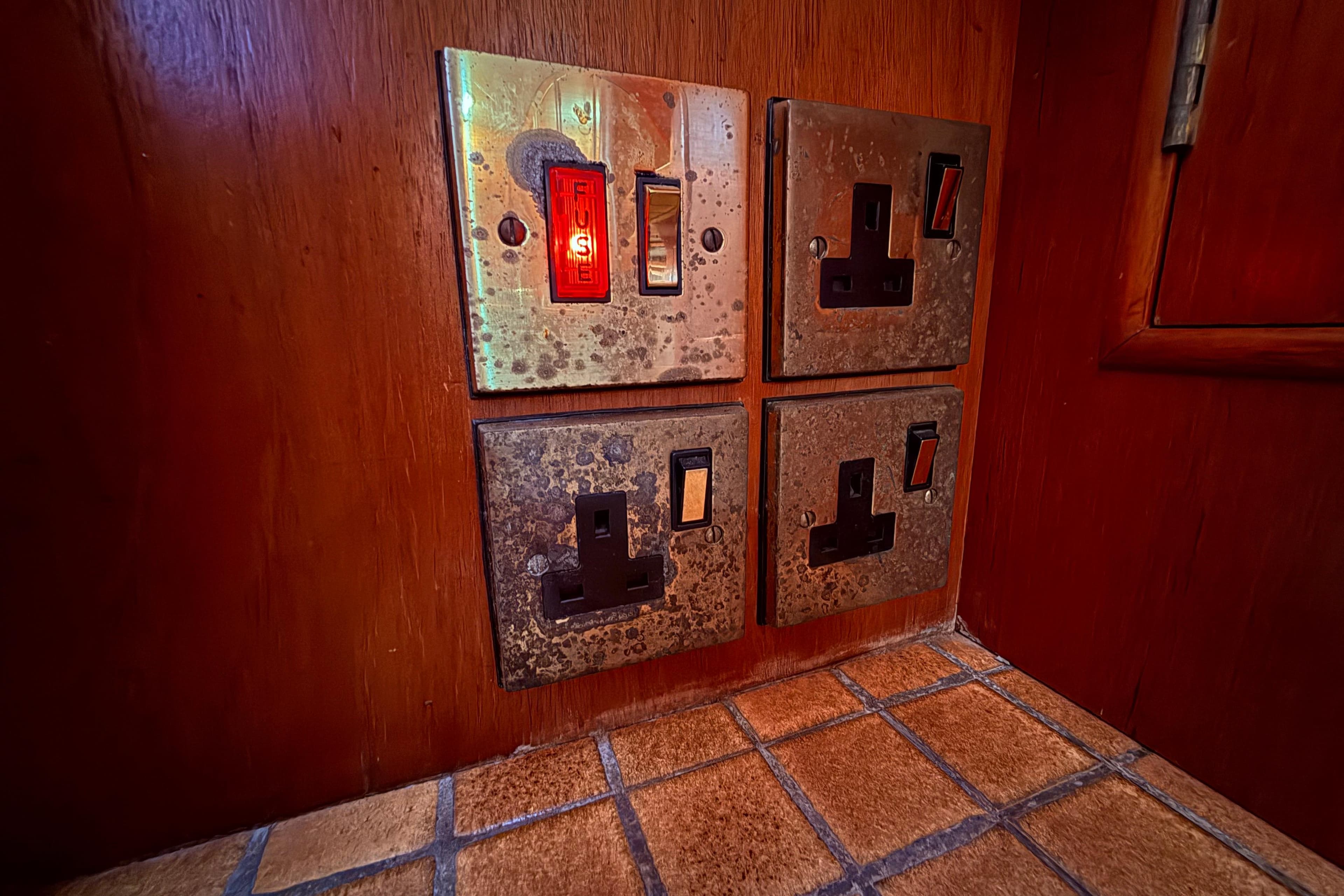 Aged electrical switches on wooden panel, Moody 134 Grenadier, 1983.