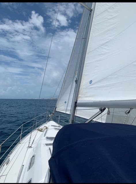 Sailing on a 2006 Beneteau Oceanis 393 under clear skies and calm seas.