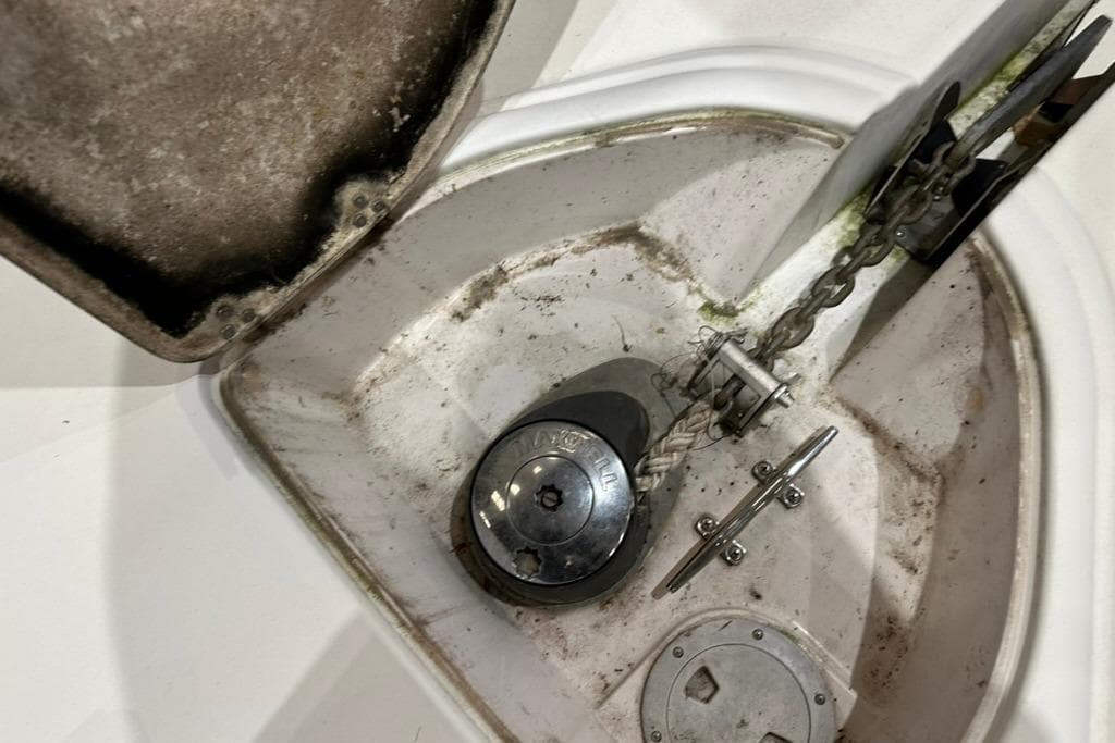 Anchor compartment of 2002 Four Winns 378 Vista boat with chain and winch.
