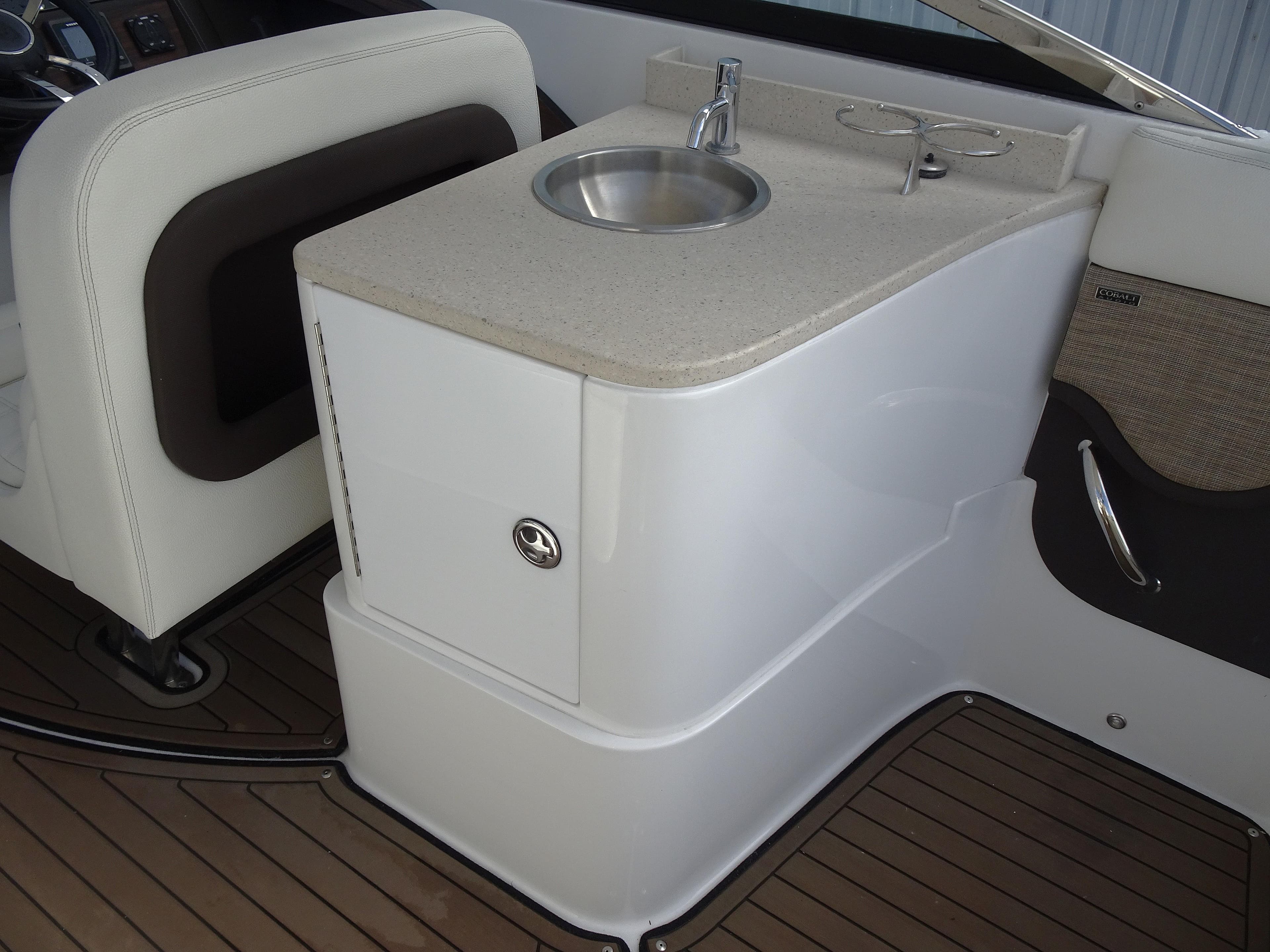 2018 Cobalt R30 boat interior with sink and storage compartment.