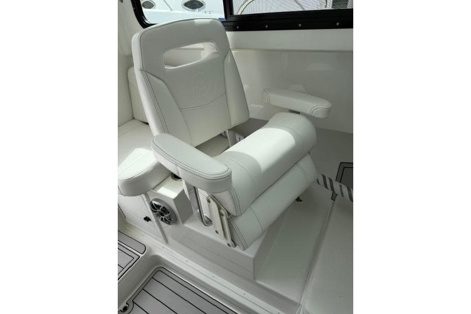 Luxury seating in 2026 Parker 227 Explorer boat, featuring white upholstery and armrests.