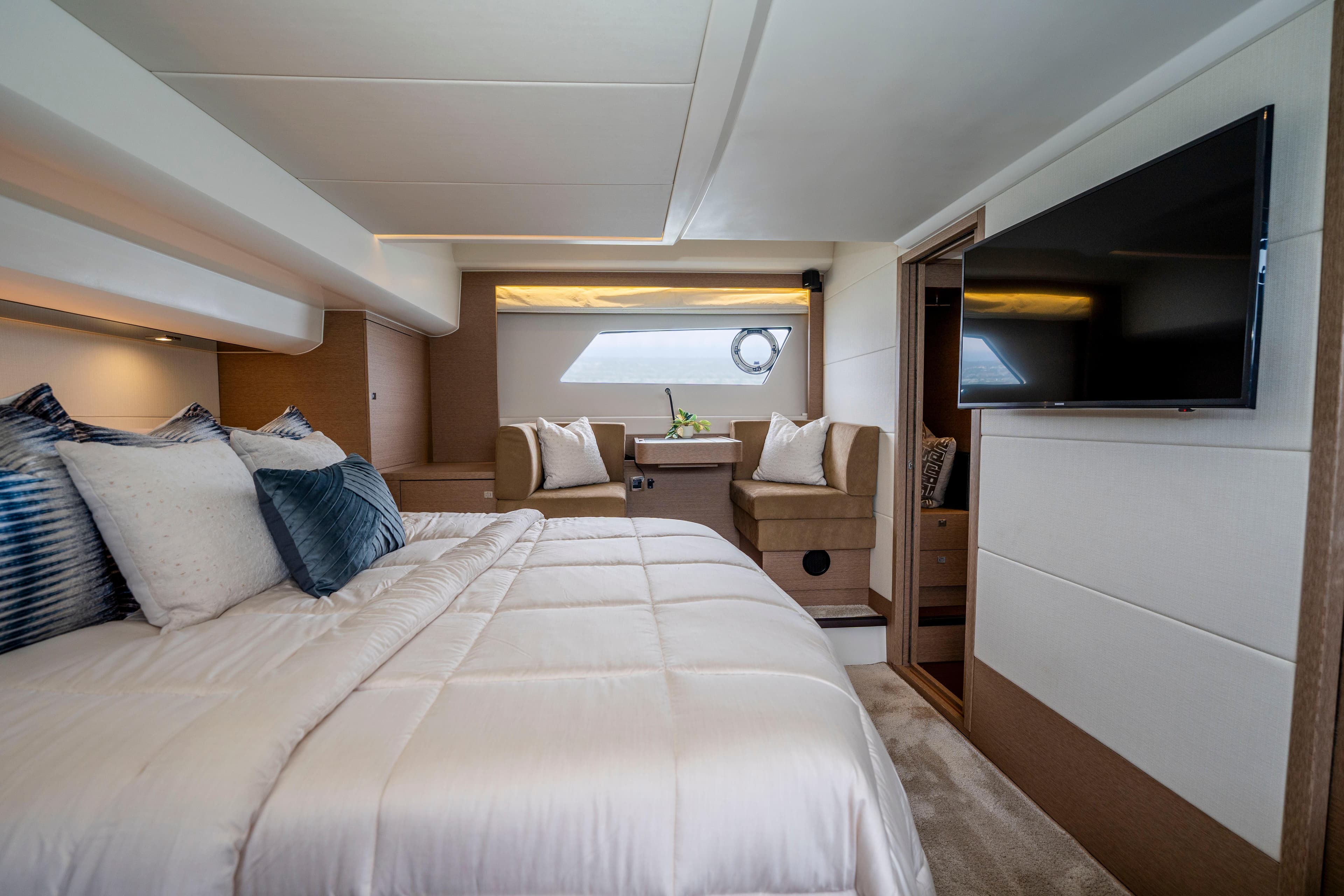 Luxurious 2018 Prestige 560 yacht bedroom with elegant decor and modern amenities.