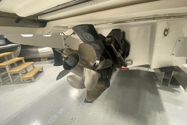 2023 Chaparral 307 SSX boat propeller and stern drive in a showroom.