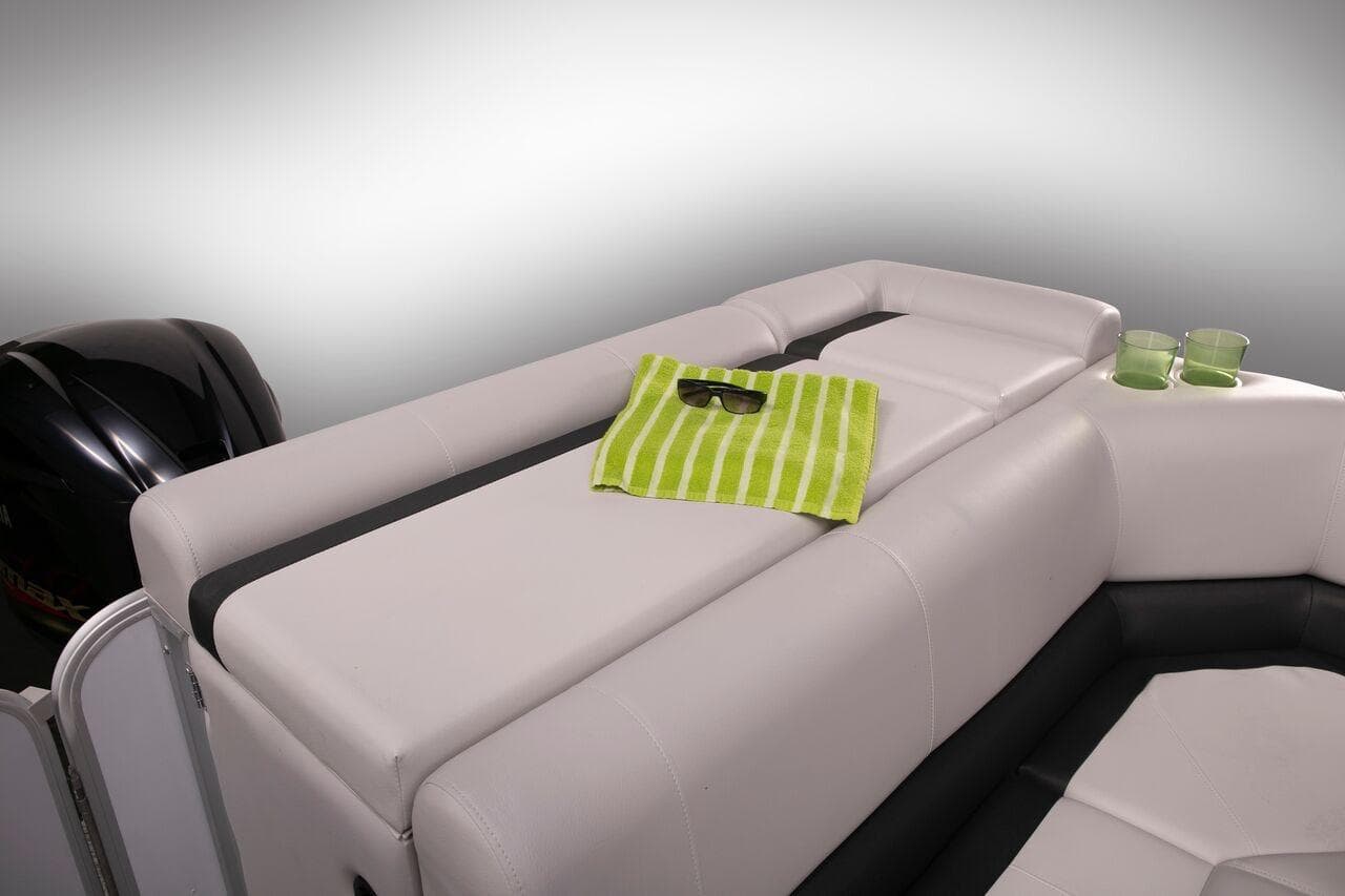 Manufacturer Provided Image: 2019 SunCatcher V322 Cruise boat interior with white seating, green towel, and sunglasses.