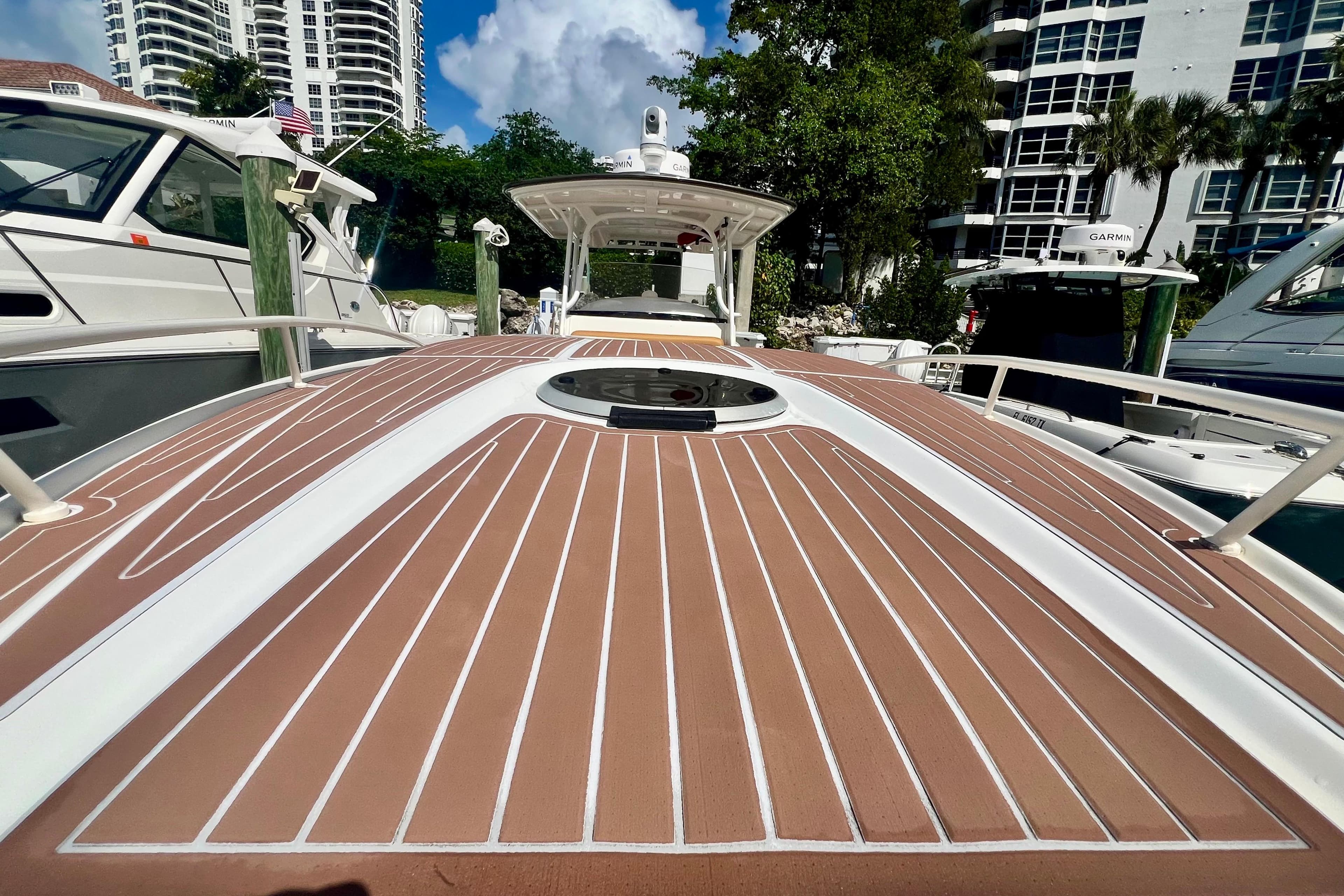 2011 Deep Impact 36 Open boat docked, showcasing sleek deck design and nearby yachts.