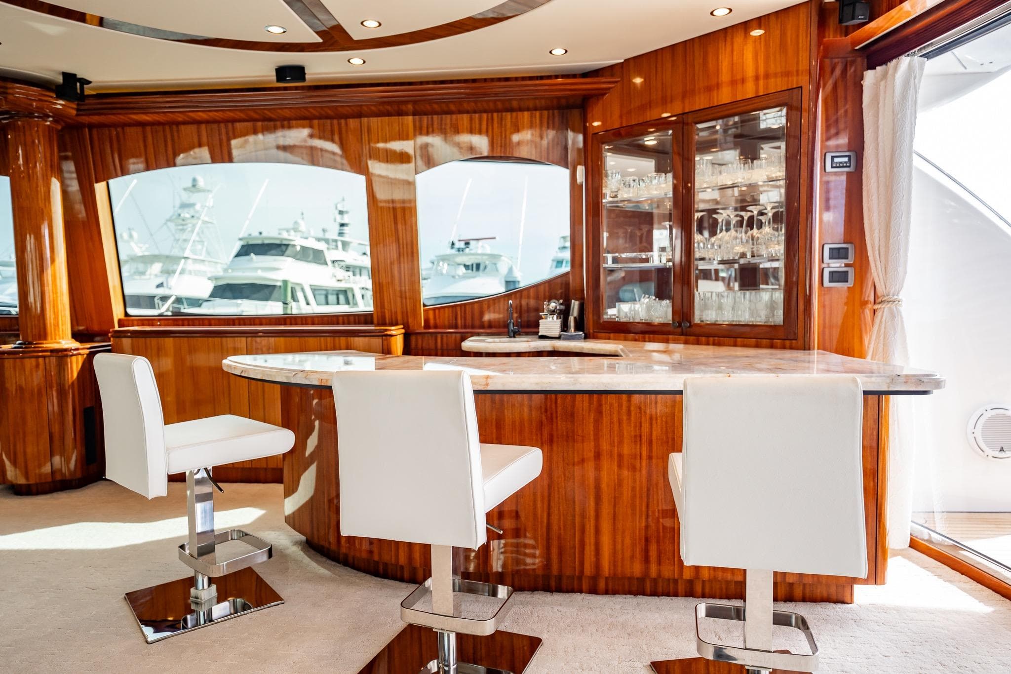 Luxurious interior of 2012 Hatteras 80 Motor Yacht with elegant bar and seating.