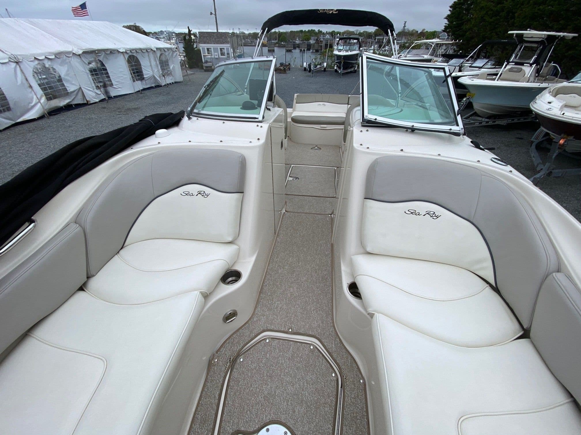 Interior of a 2006 Sea Ray 240 Sundeck boat with white seating.