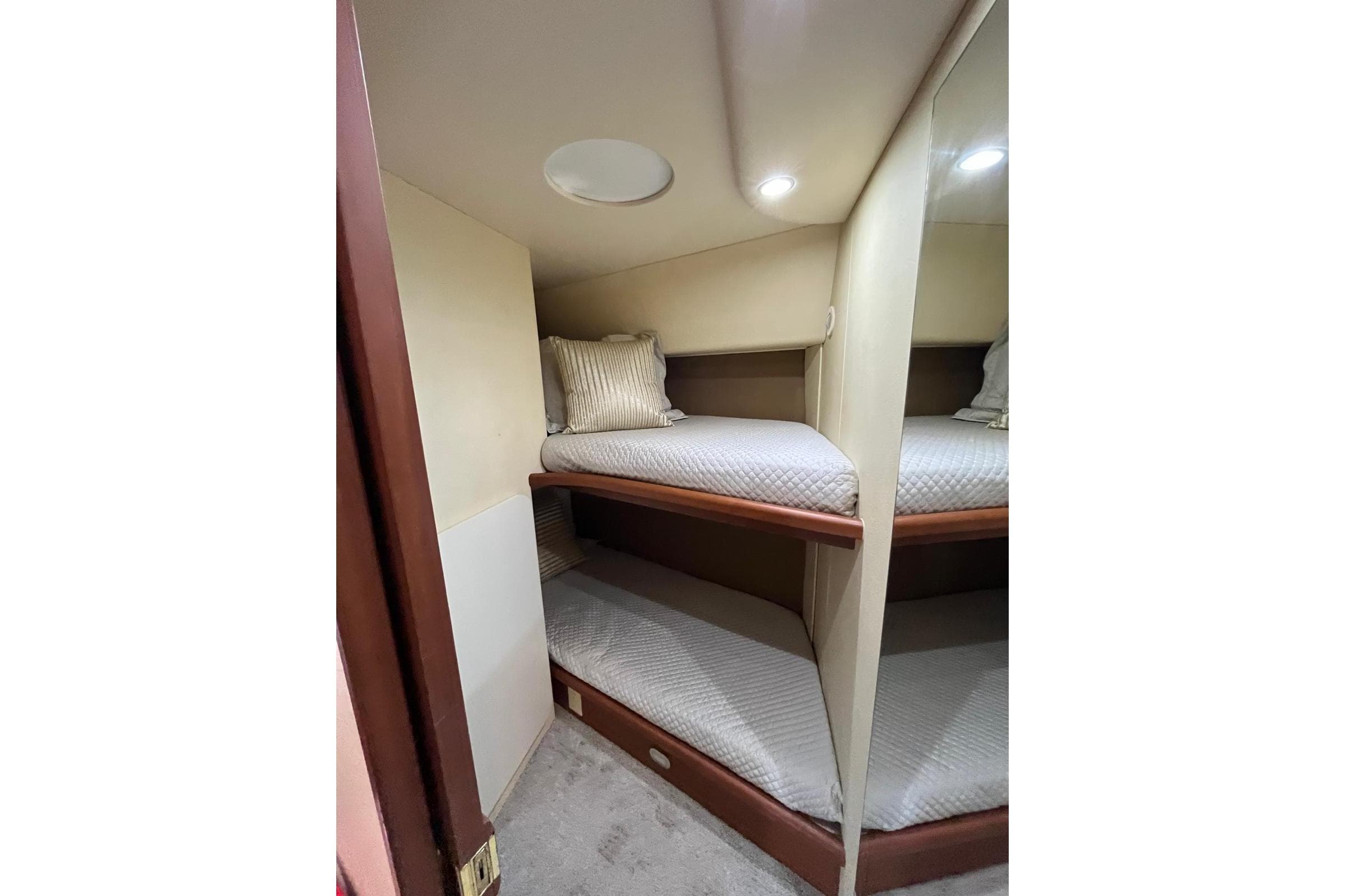 2005 Silverton 34 Convertible yacht interior with cozy bunk beds and soft lighting.