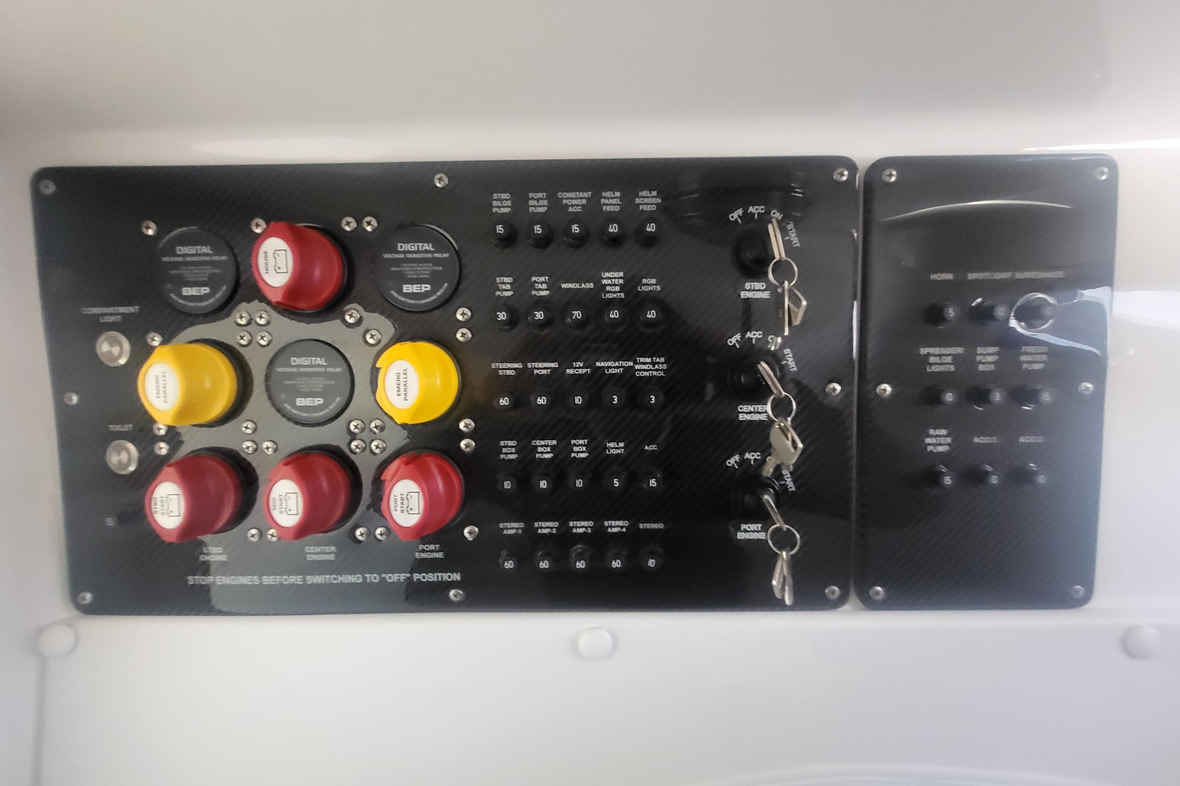Control panel of a 2025 Fountain 34 SC boat with switches and dials.