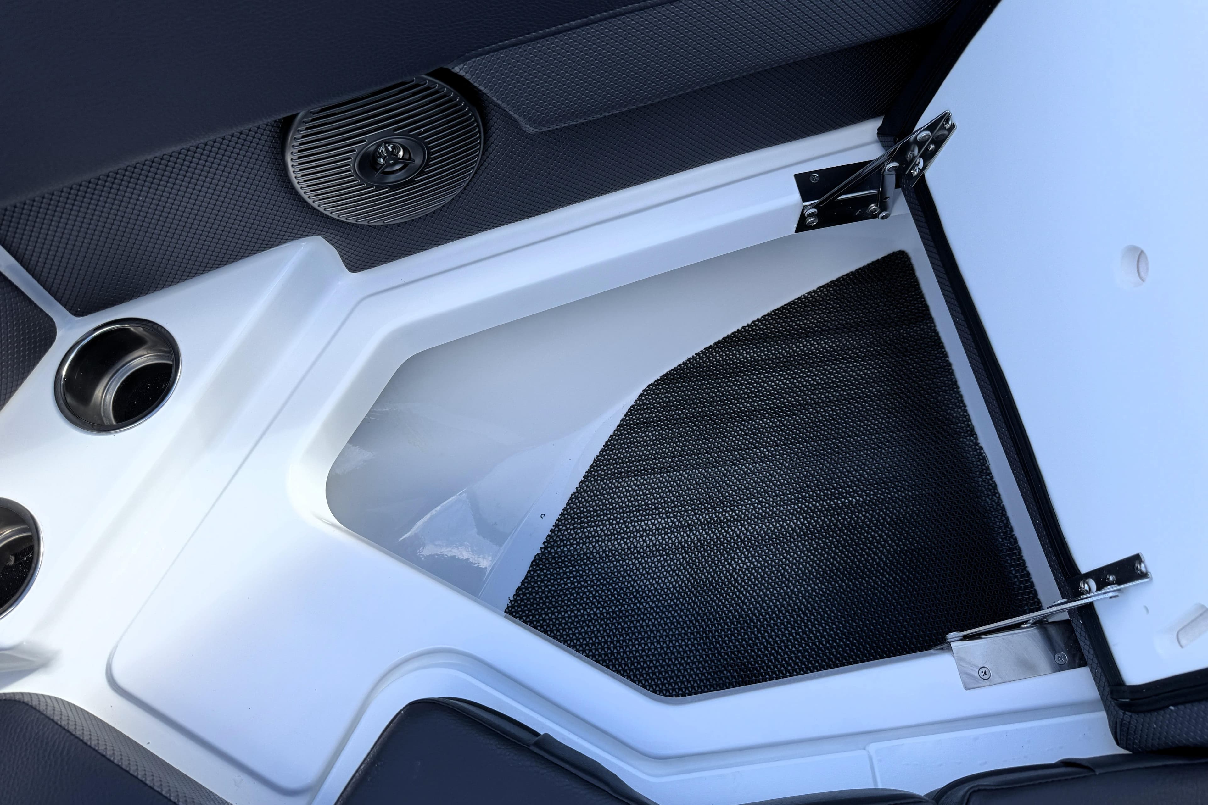 Open storage compartment in 2026 Scarab 210 LX boat interior.