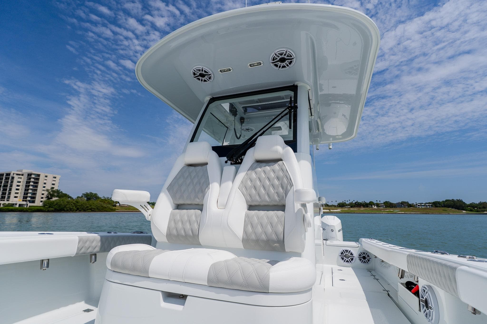 2023 Freeman 28 boat with luxurious seating, sleek design, and scenic waterfront view.