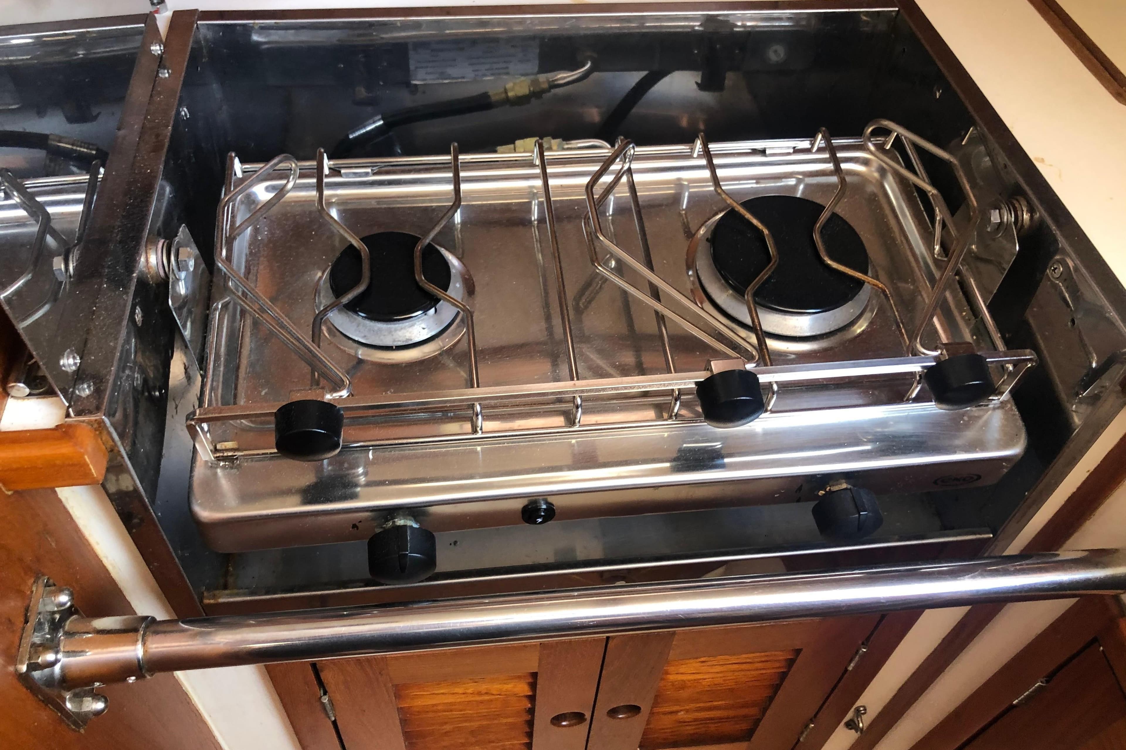 1982 Tartan 33 yacht kitchen with a two-burner stainless steel stove.