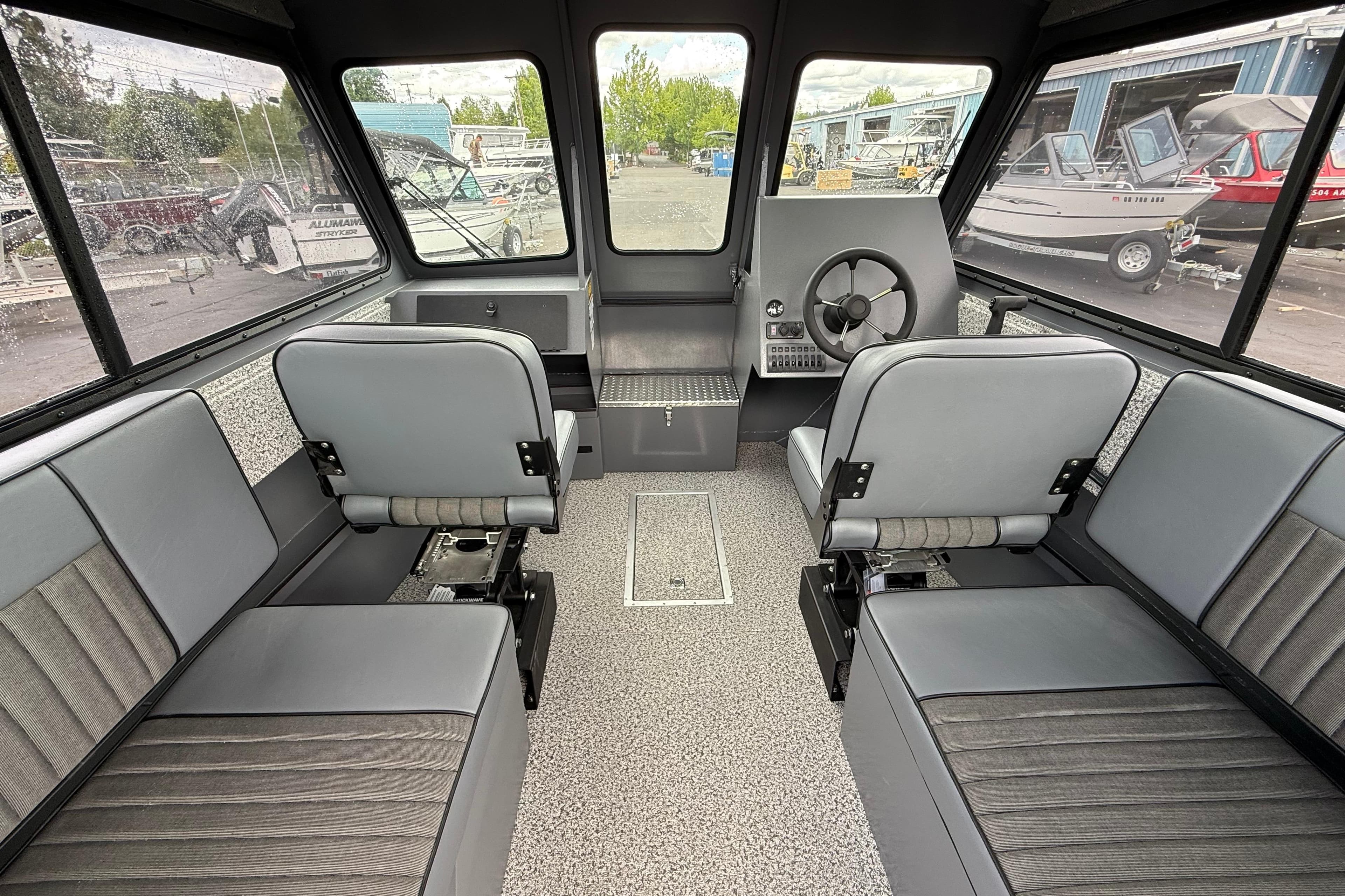 2026 Alumaweld Intruder 22 HT boat interior with gray seating and steering console.