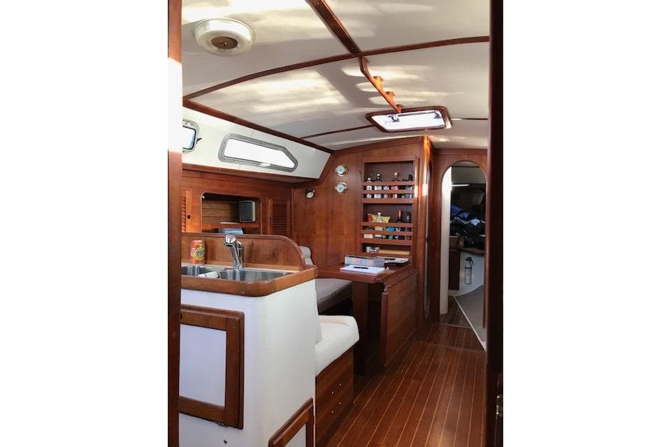 Interior of 1989 Freedom 38 Sloop sailboat with wooden cabinetry and seating area.