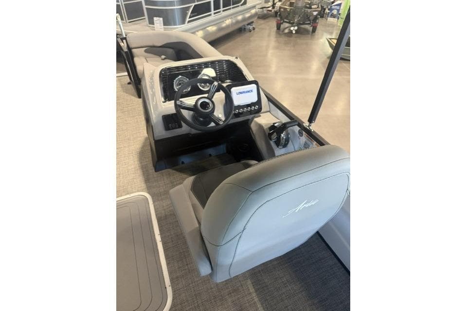 2026 Barletta ARIA 22UC boat interior with steering wheel and control panel.