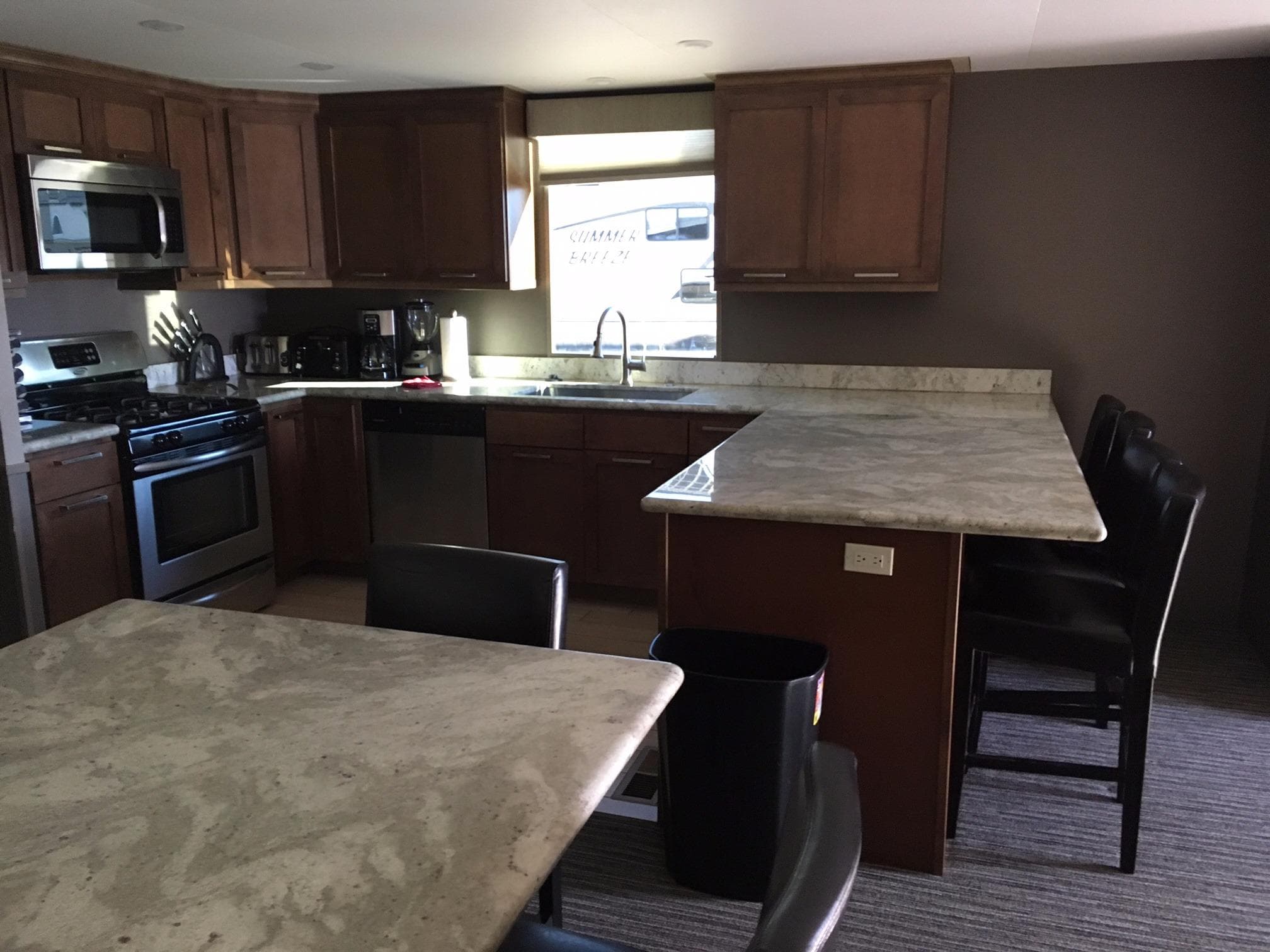 Modern kitchen with granite countertops and wooden cabinets, Bravada Discovery 2015.