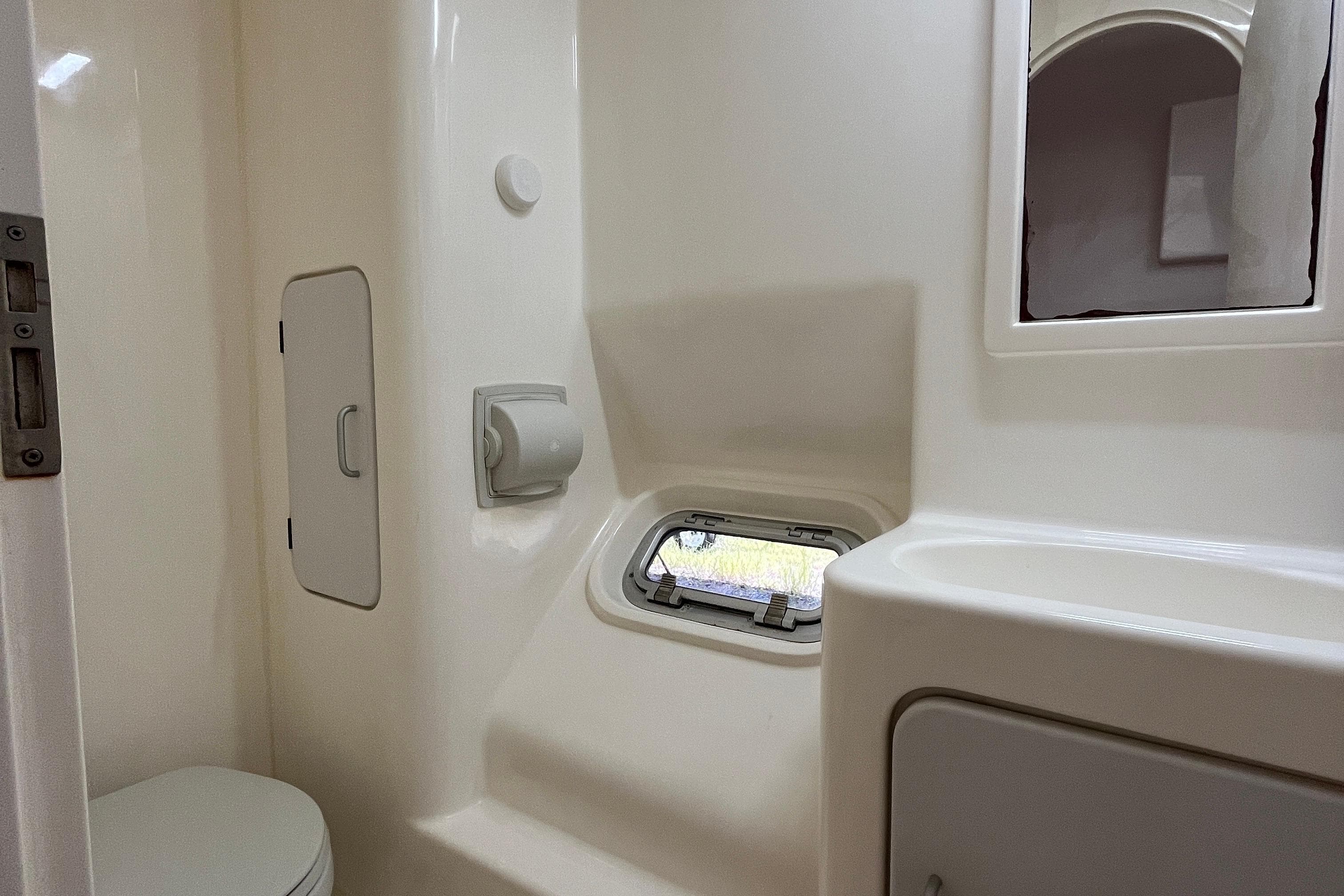 Bathroom interior of 2013 Voyage Yachts 520, featuring compact design and window.