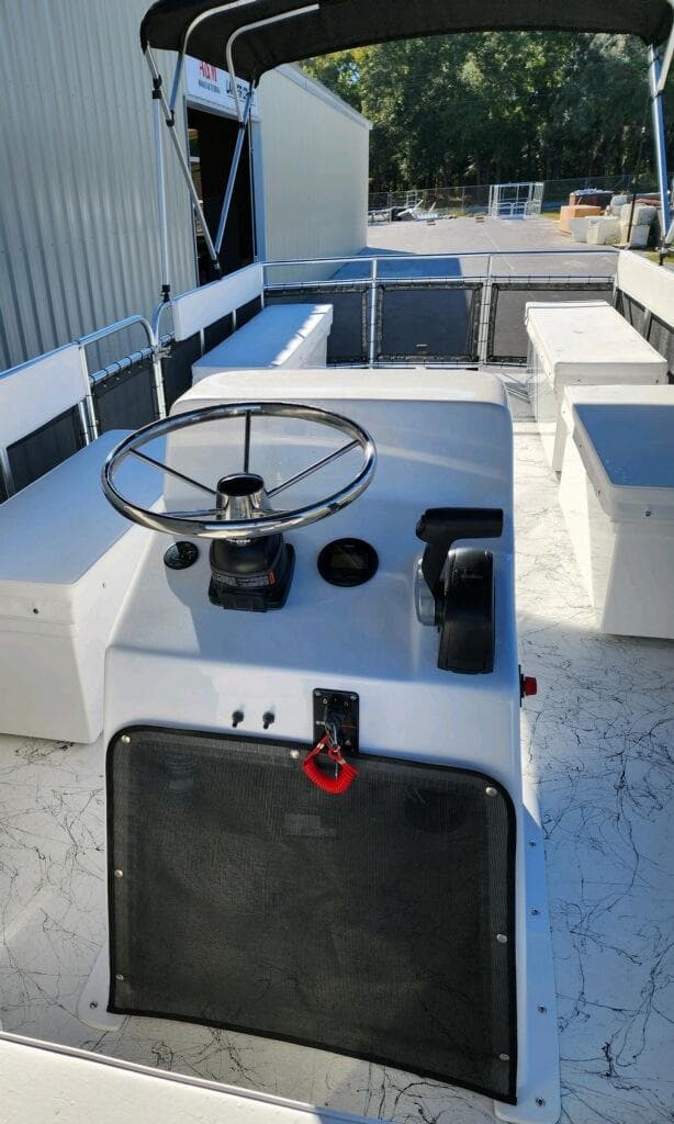 2025 A&M Manufacturing Salty 23 boat interior with steering console and seating.