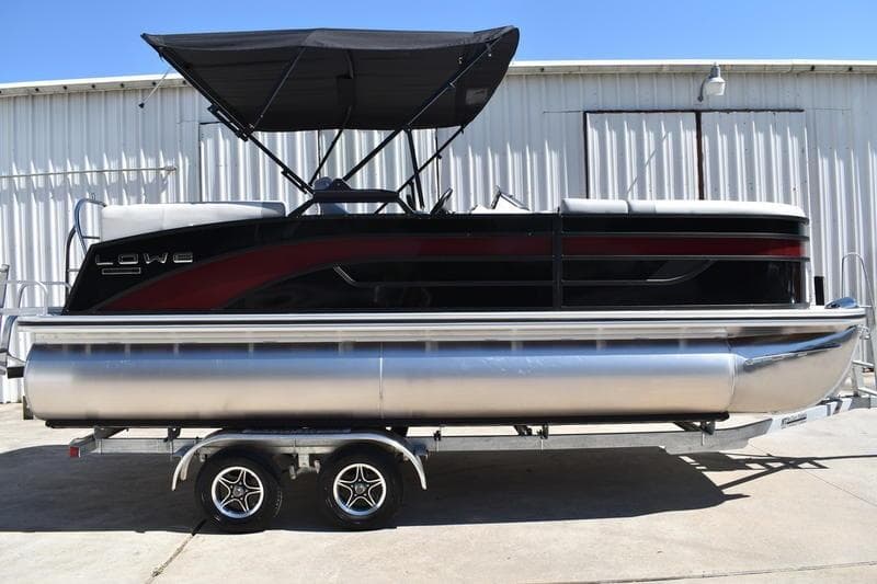2026 Lowe SS 210 WT pontoon boat with canopy on trailer, parked outdoors.