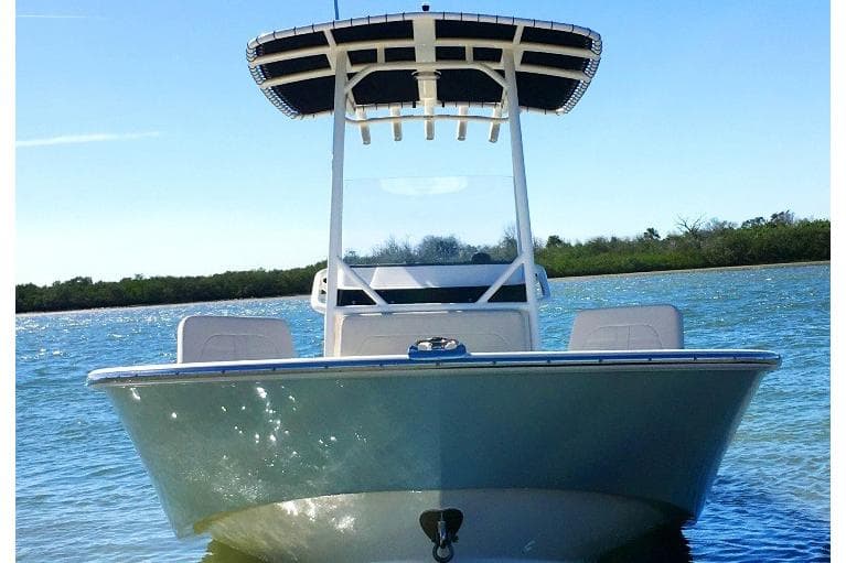 Manufacturer Provided Image: 2026 Boston Whaler 210 Montauk boat on water, clear sky, front view.