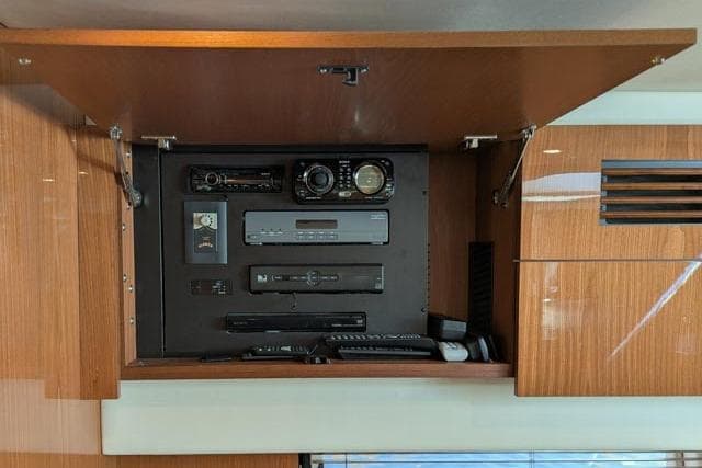 Control panel inside 2013 Sea Ray 470 Sundancer yacht, featuring various electronic devices.