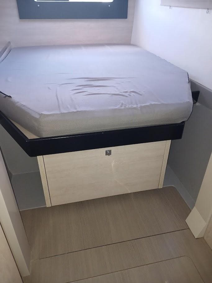 2019 Leopard 40 interior cabin with a neatly made bed and storage space.