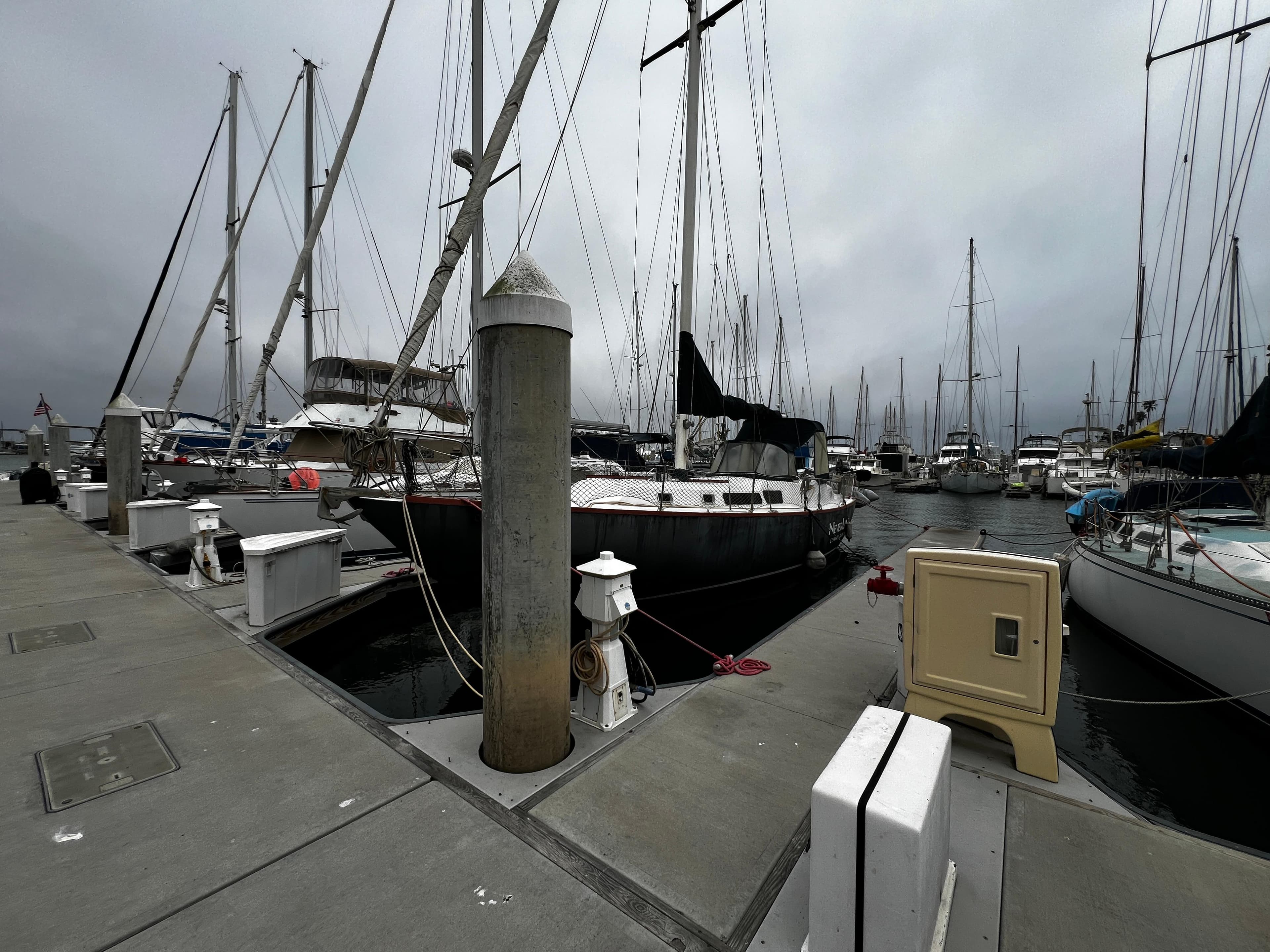 Sailboats docked at a marina, featuring a 1974 Irwin 37 Center Cockpit.