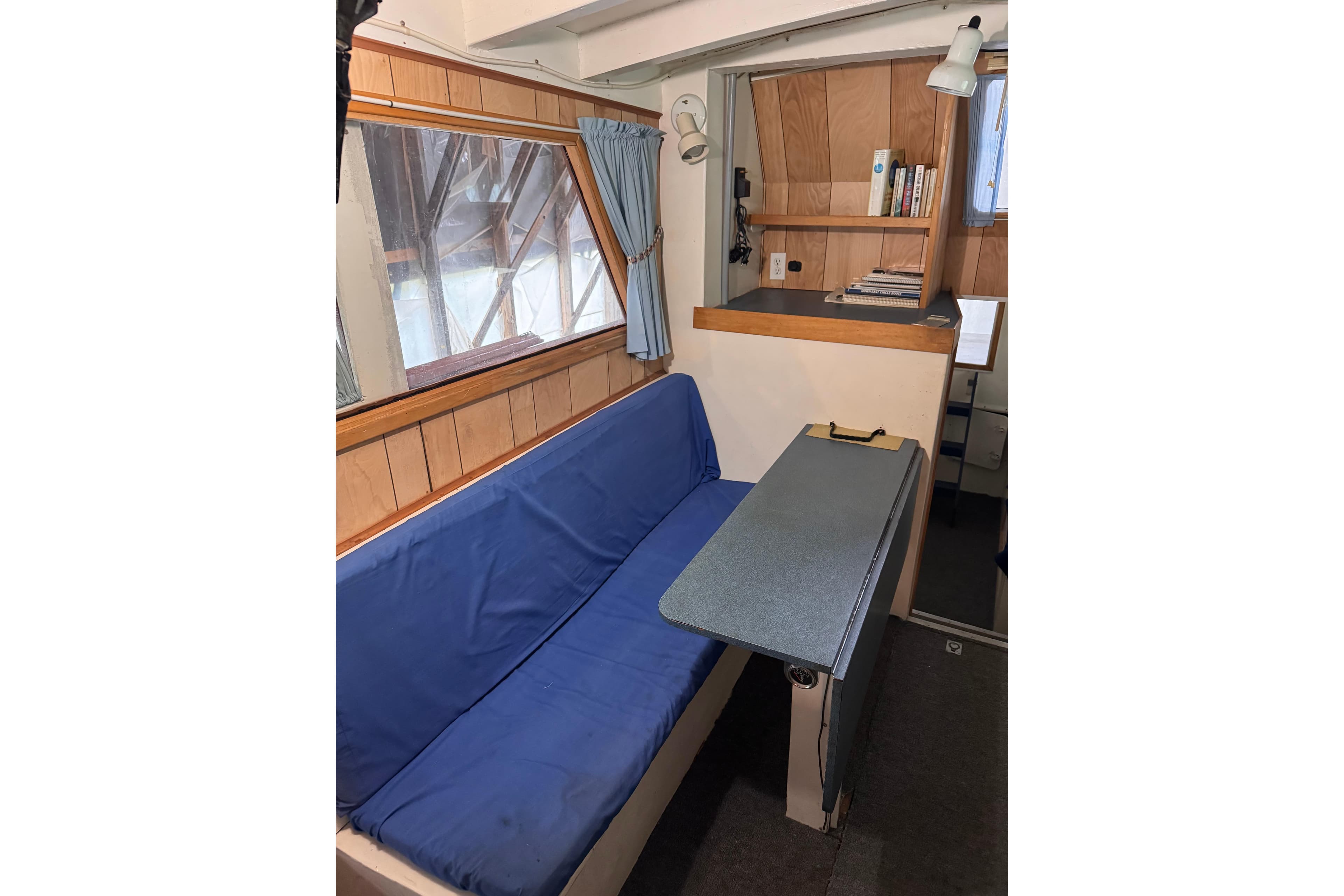Interior of 2000 Custom Yukon 42 Trawler with blue seating and wooden accents.