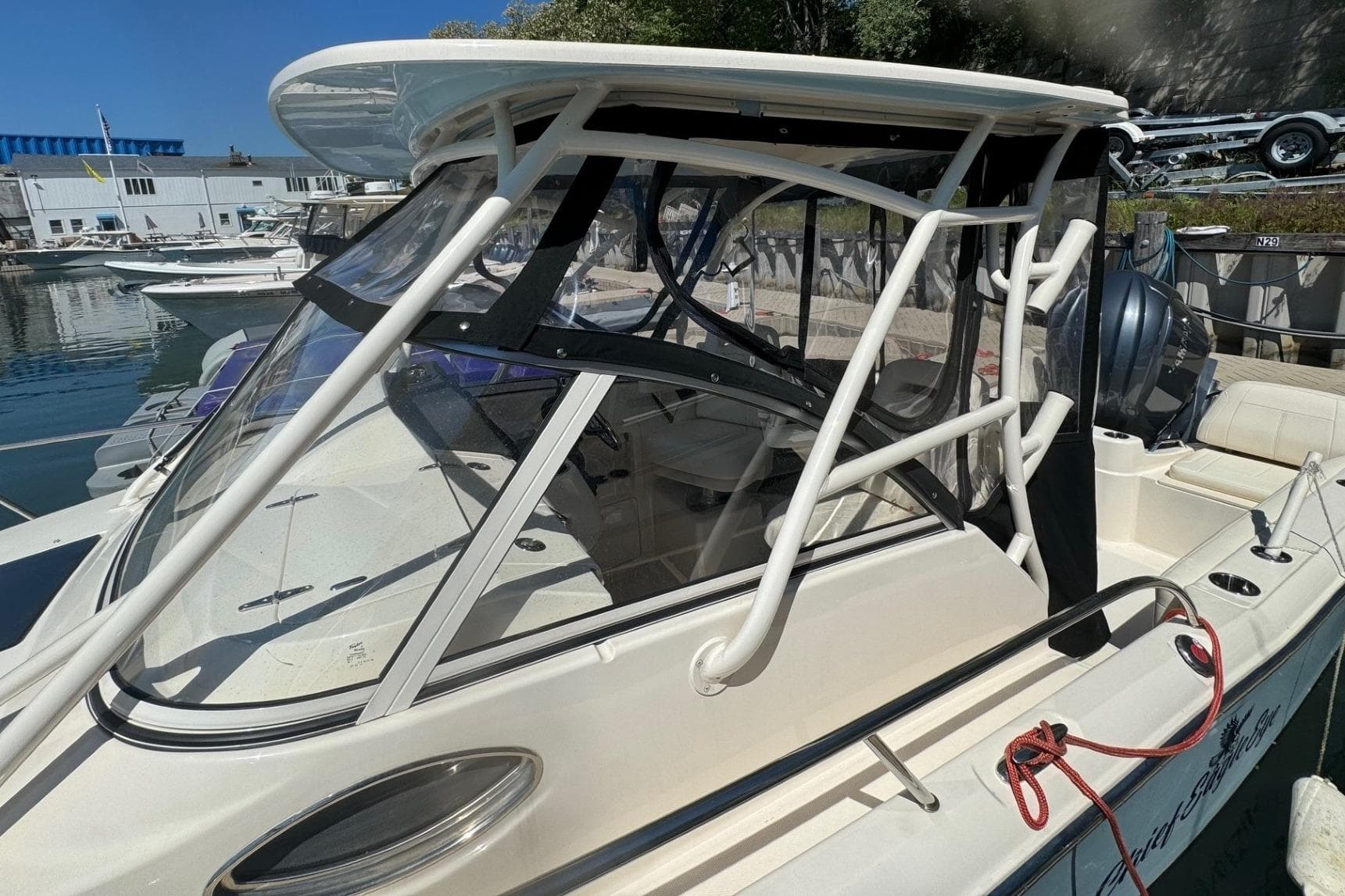 2023 Grady-White Adventure 218 boat docked at marina, featuring sleek design and sturdy frame.