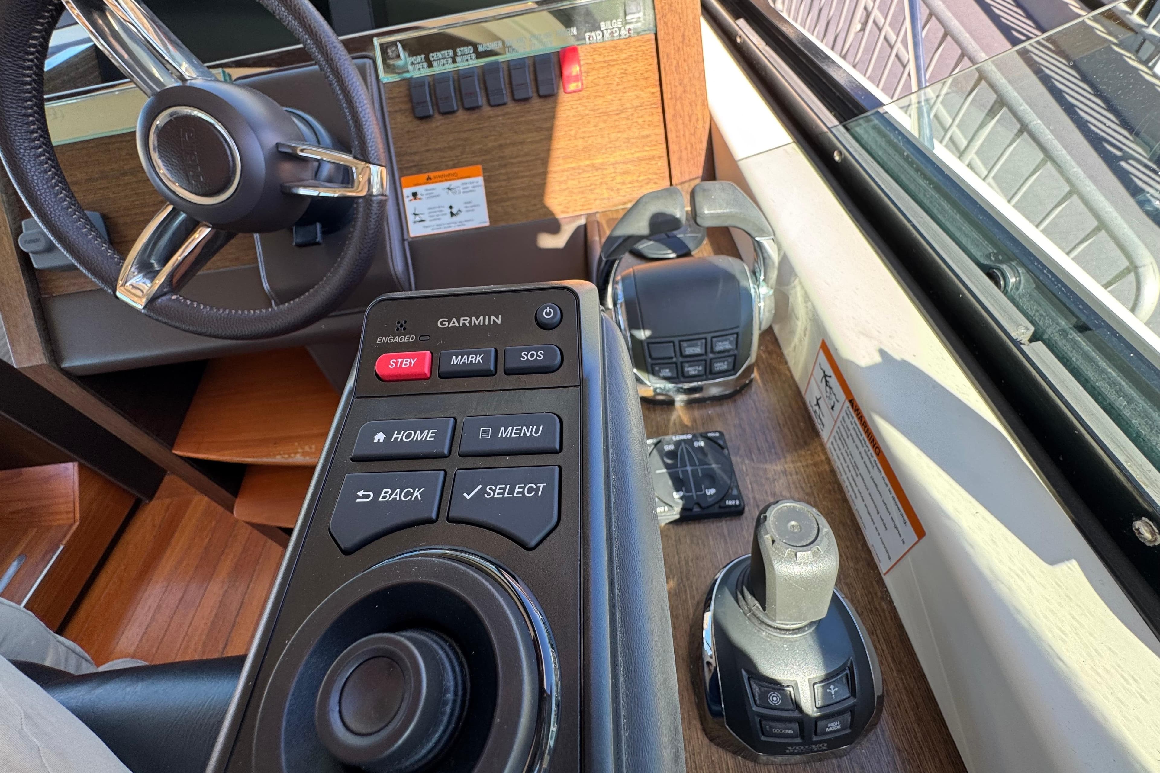 2016 Tiara Yachts 50 Coupe helm with Garmin controls and steering wheel.