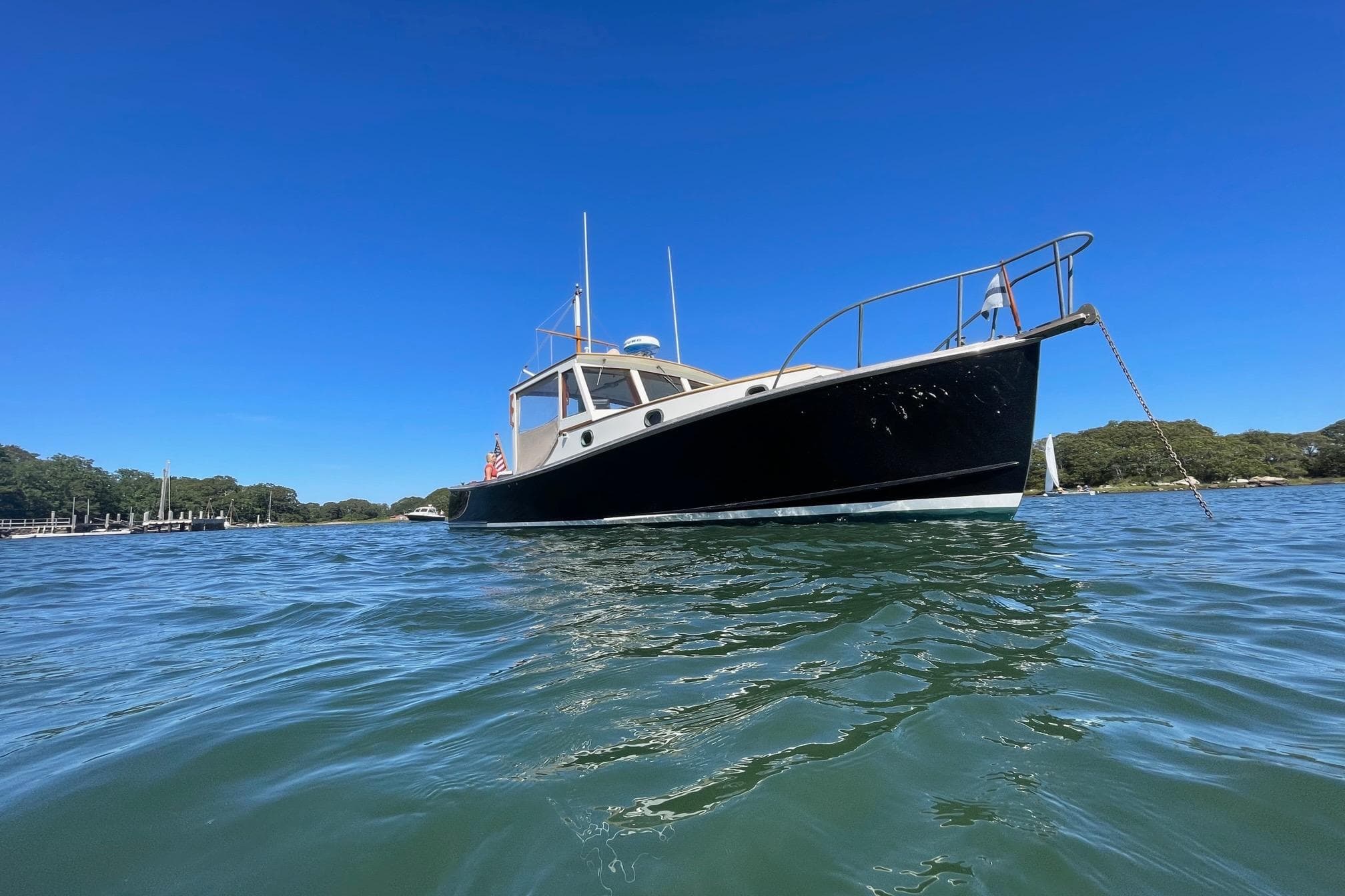 1985 John Williams Stanley 36 boat on calm water under clear blue sky.