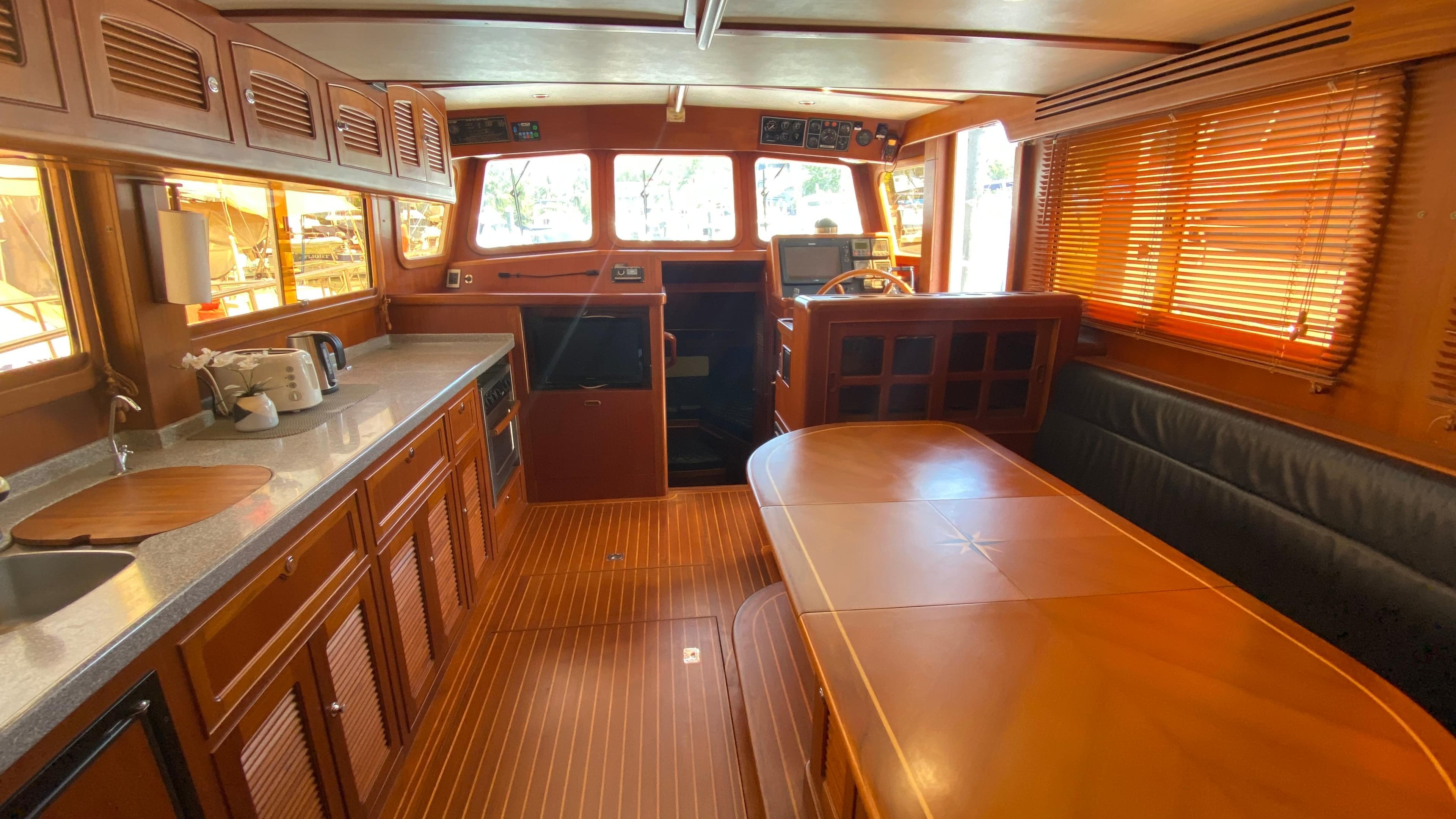 Interior of 2005 Selene 40 Ocean Trawler with wood finish and dining area.