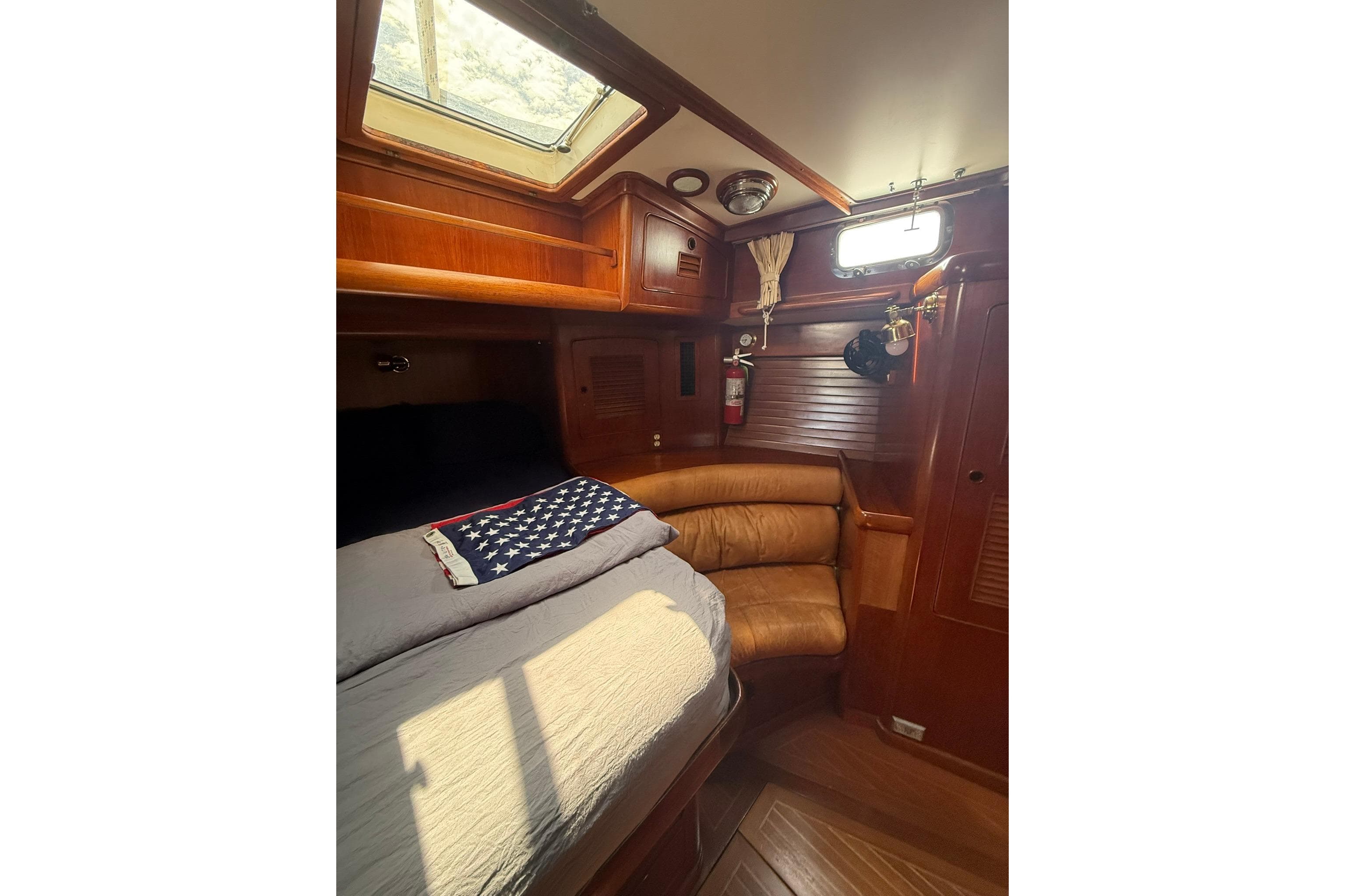 Cozy cabin interior of 1986 Little Harbor LH46 yacht with wooden finishes and natural light.