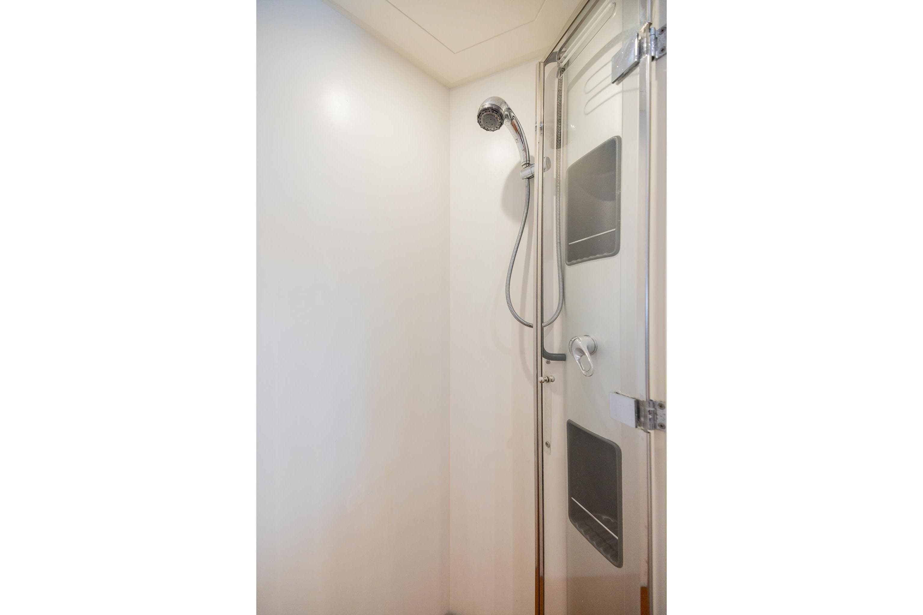 Shower area inside a 2007 Pershing 56 yacht, featuring modern fixtures and sleek design.