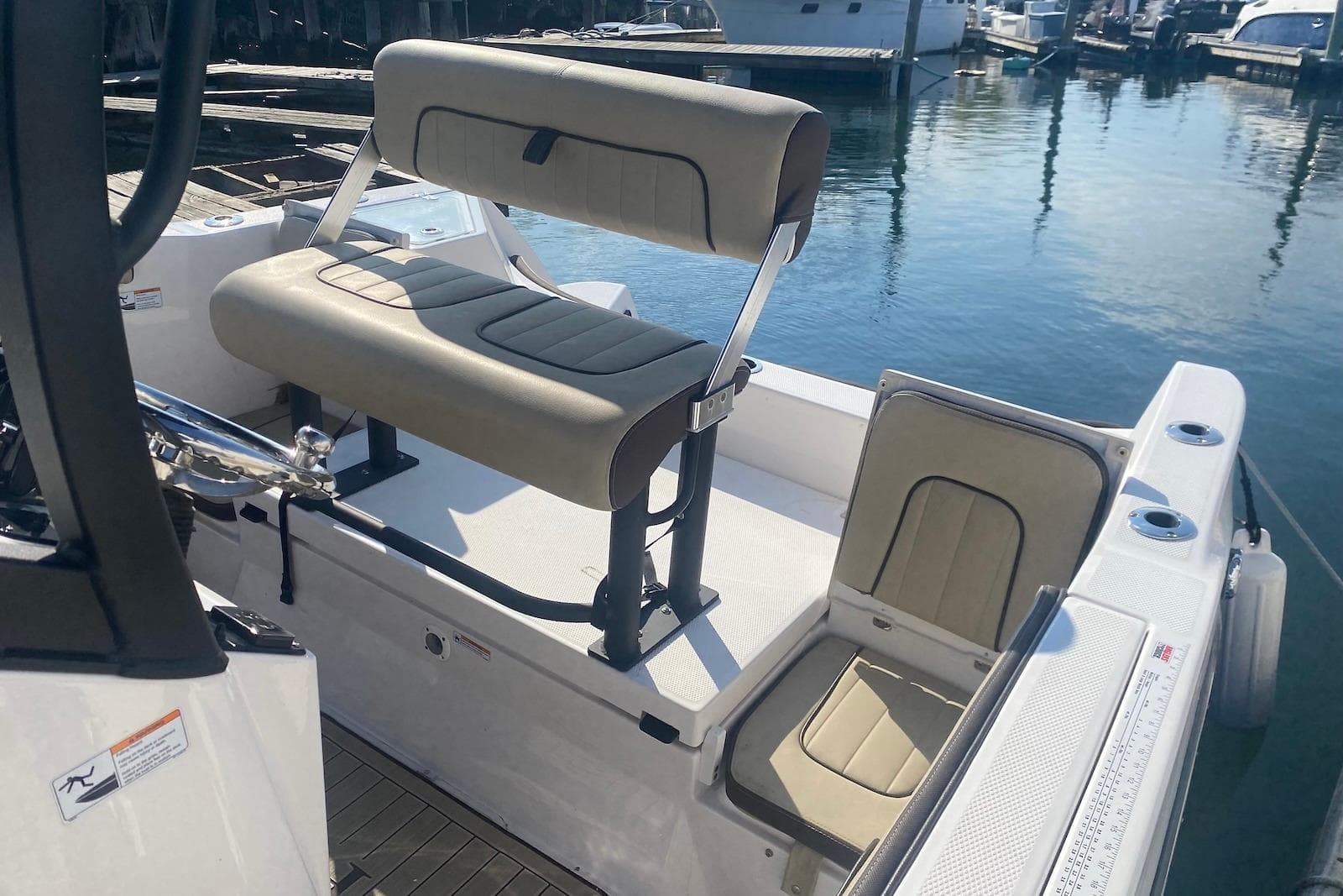 2024 Yamaha Boats 222 FSH Sport E interior seating, docked at marina.