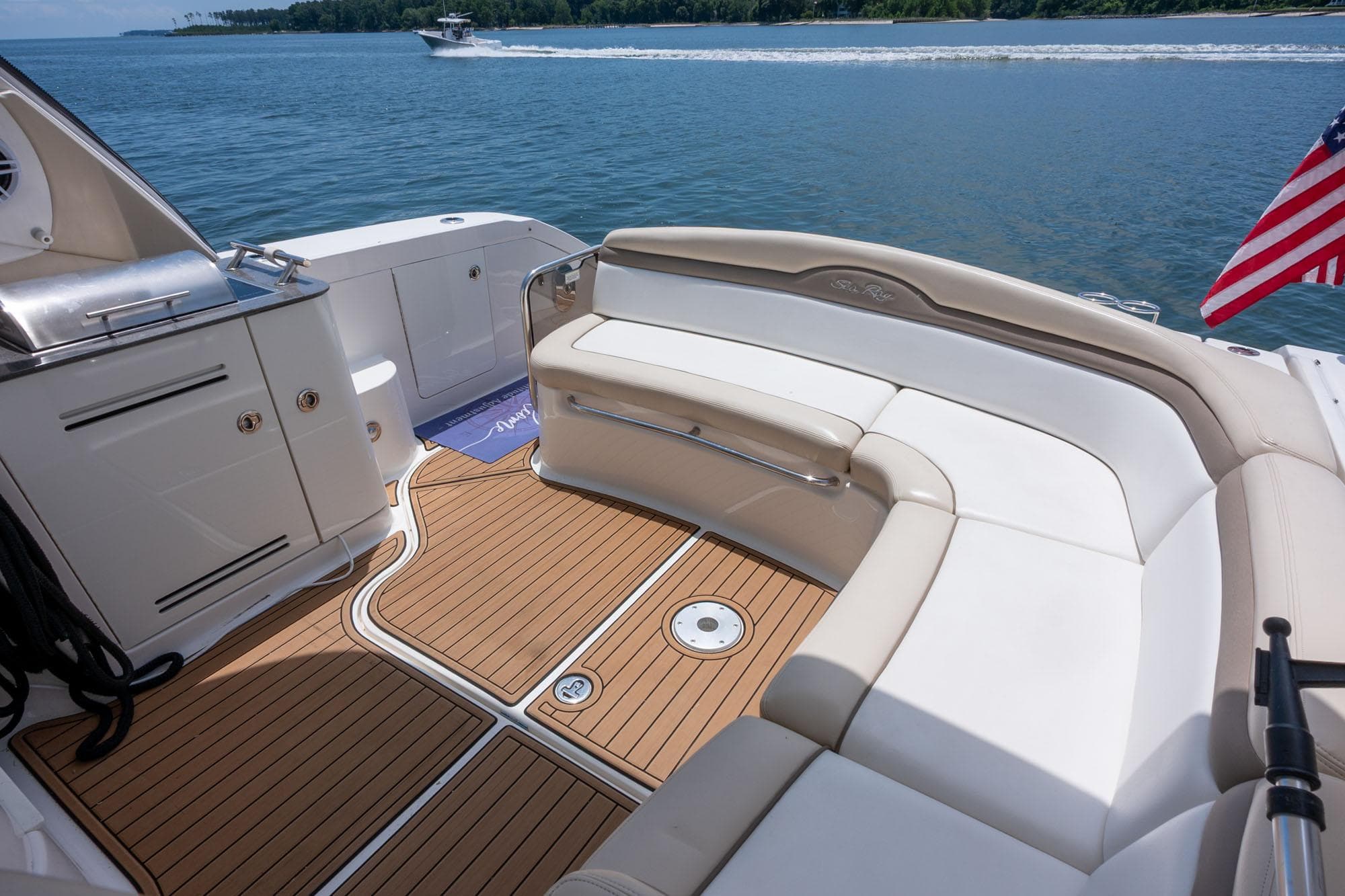 Luxurious 2013 Sea Ray 370 Sundancer yacht interior with elegant seating and scenic water view.