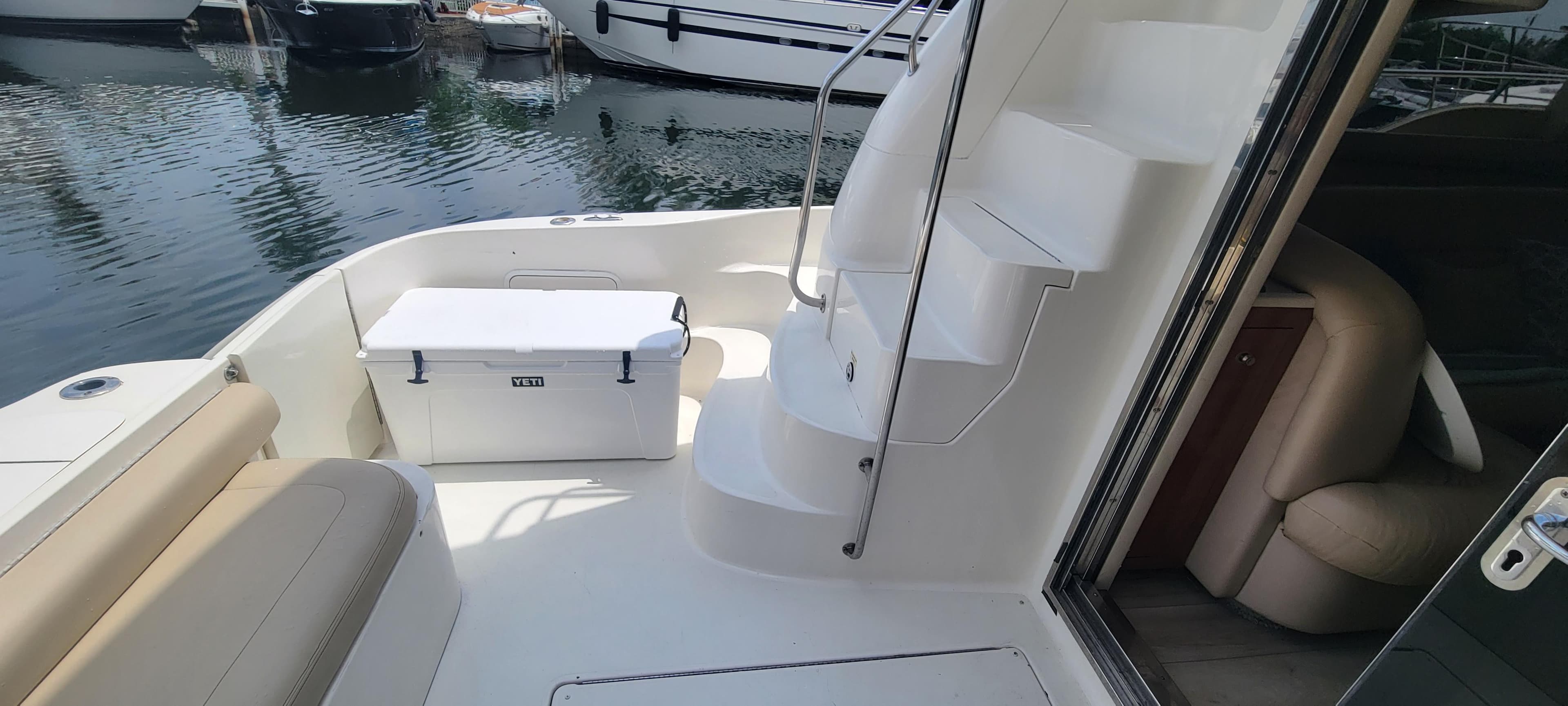 2004 Sea Ray 480 Sedan Bridge yacht deck with seating and cooler.