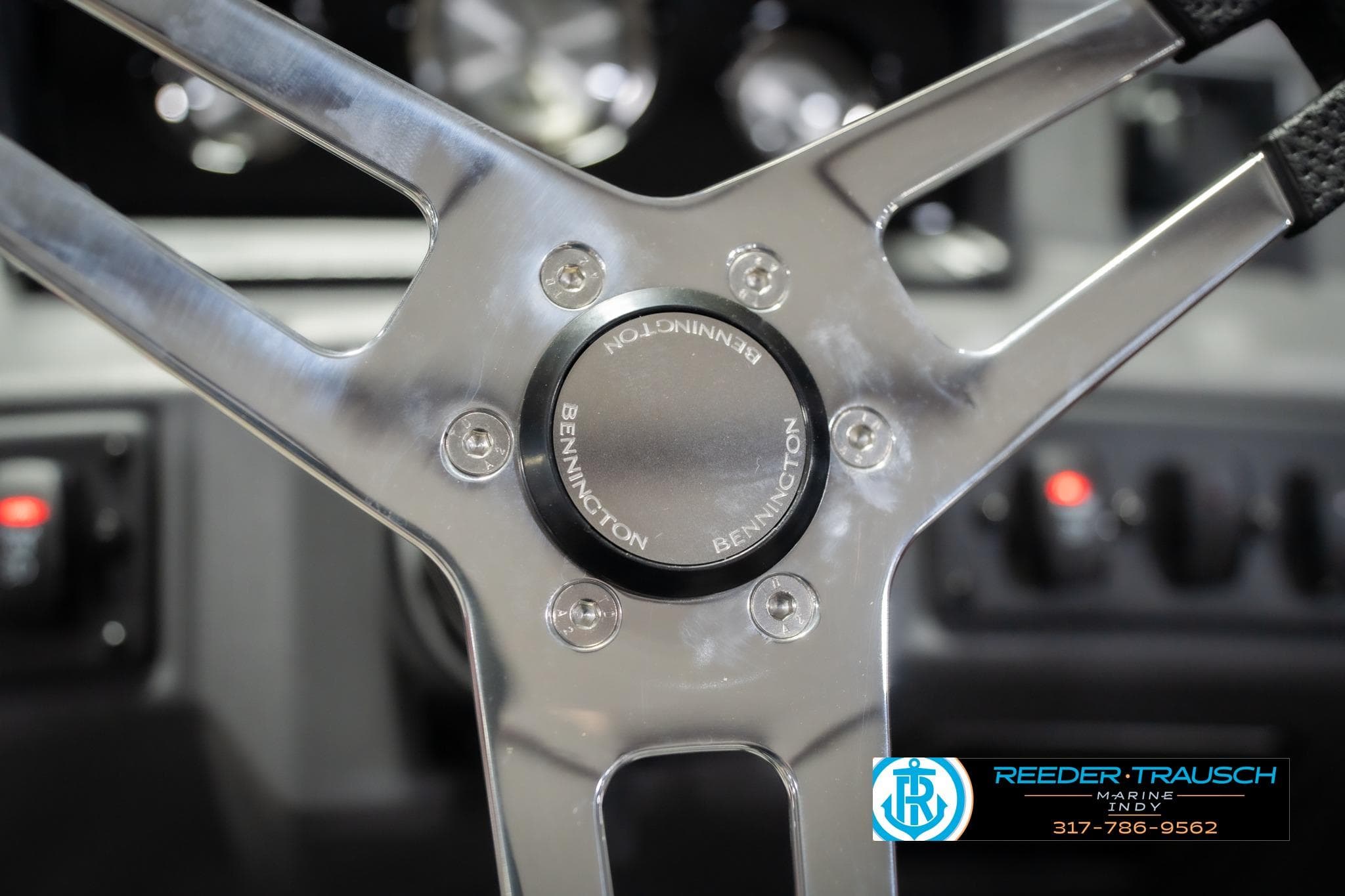 Steering wheel of 2026 Bennington 20 SSR boat, featuring sleek metallic design.