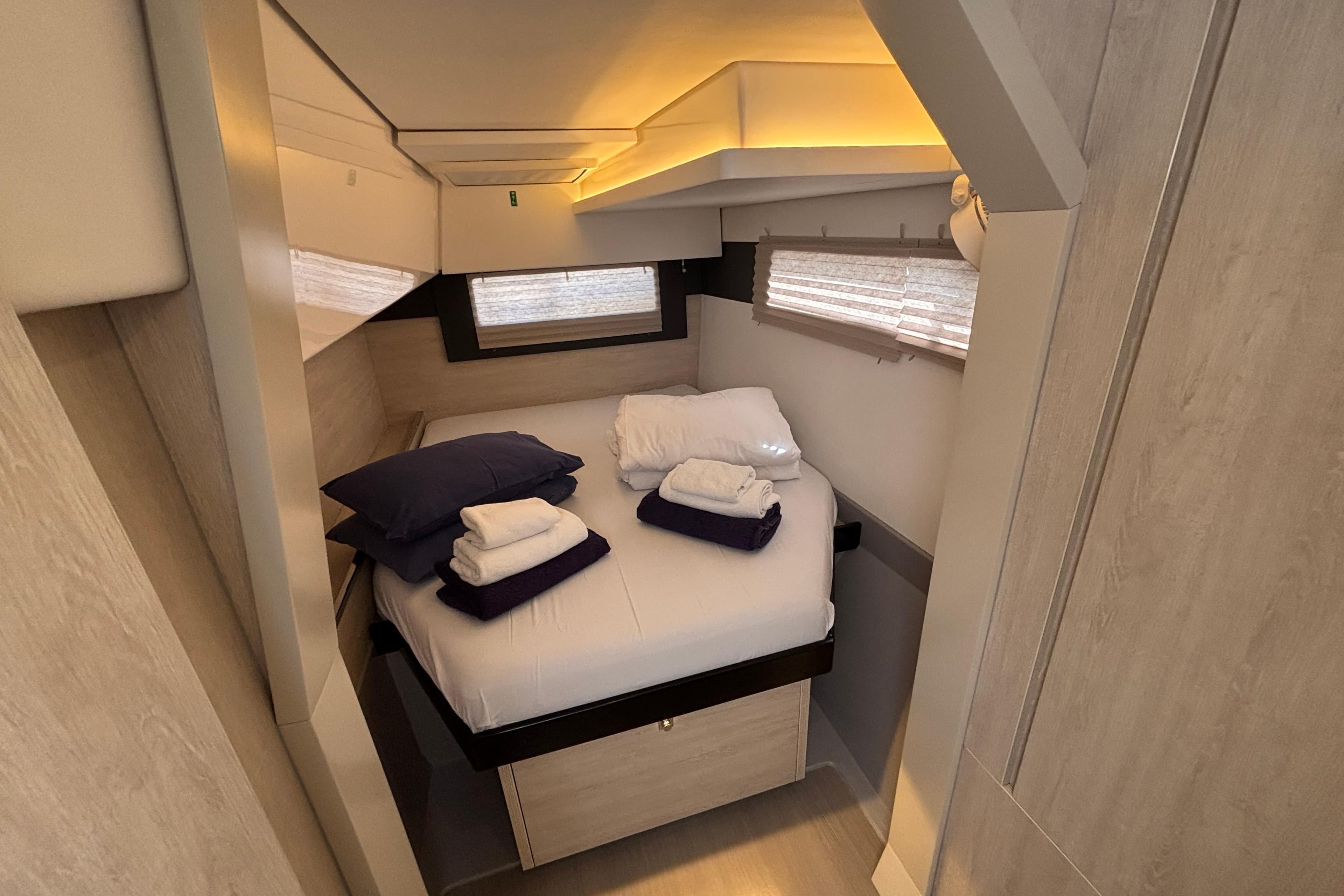 Cozy cabin interior of 2020 Leopard 40 yacht with neatly arranged bedding.