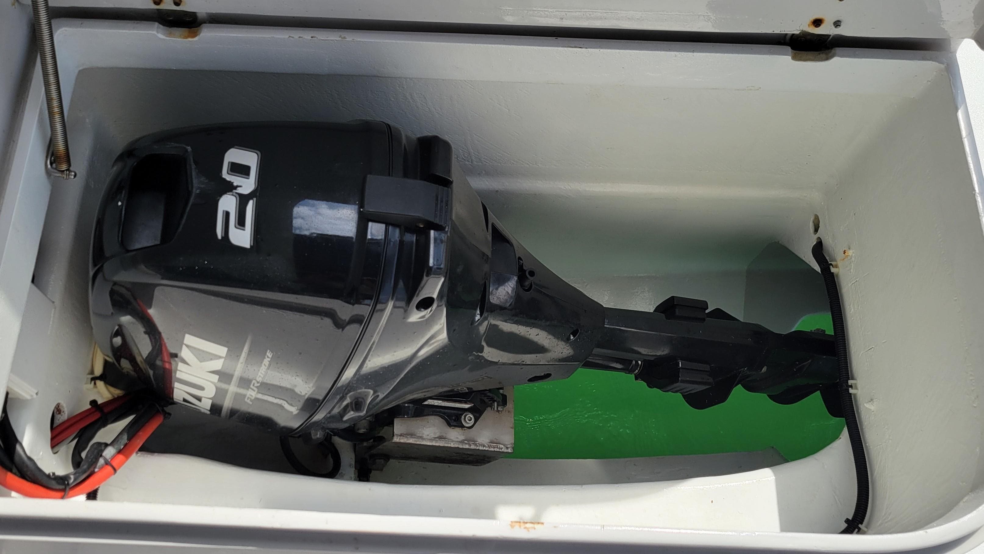 Outboard motor in storage compartment of 2011 Andaman Cabriolet 39 boat.