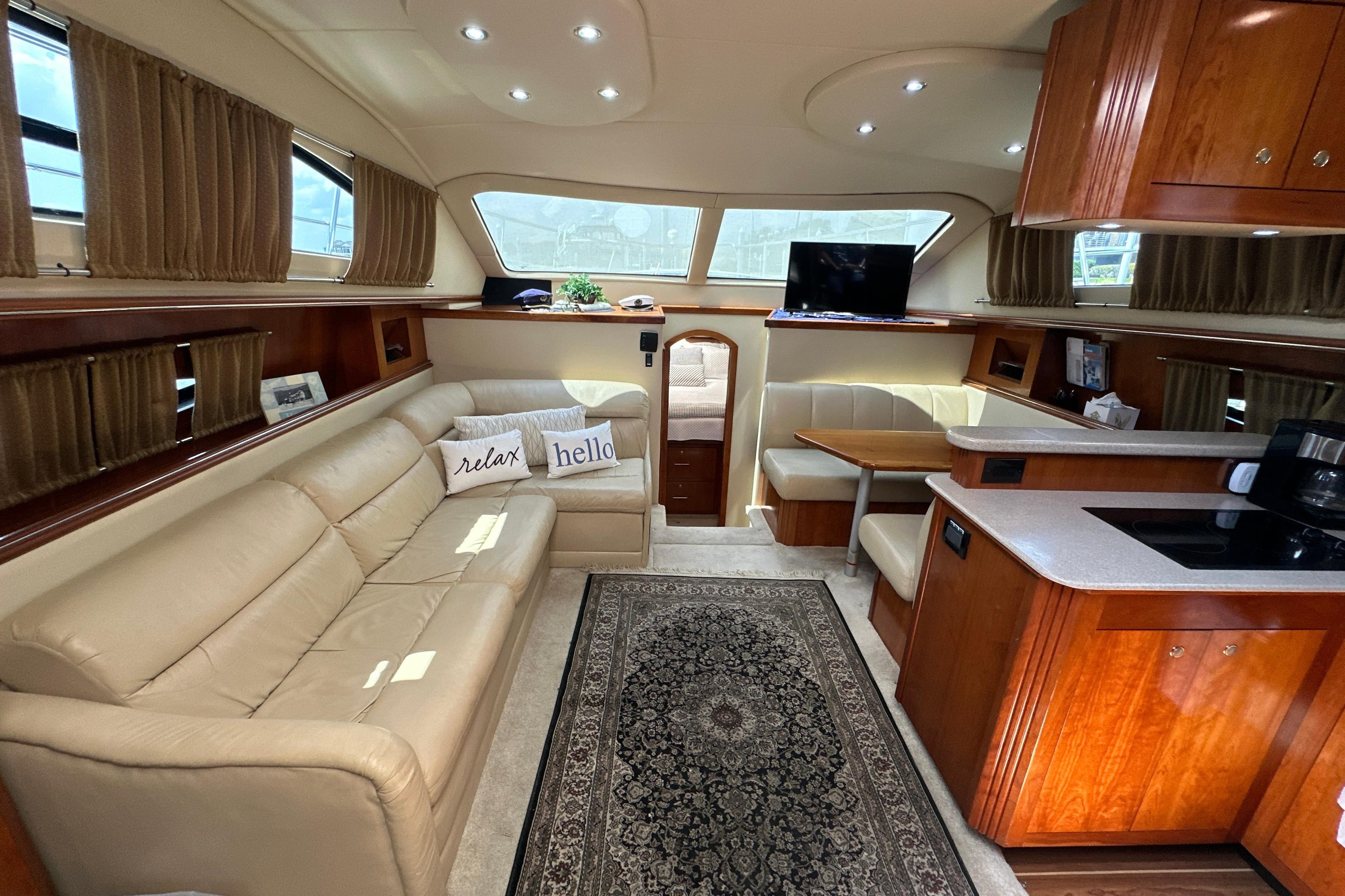 Luxurious interior of 2004 Cruisers Yachts 405 Express Motoryacht with leather seating and wood cabinetry.