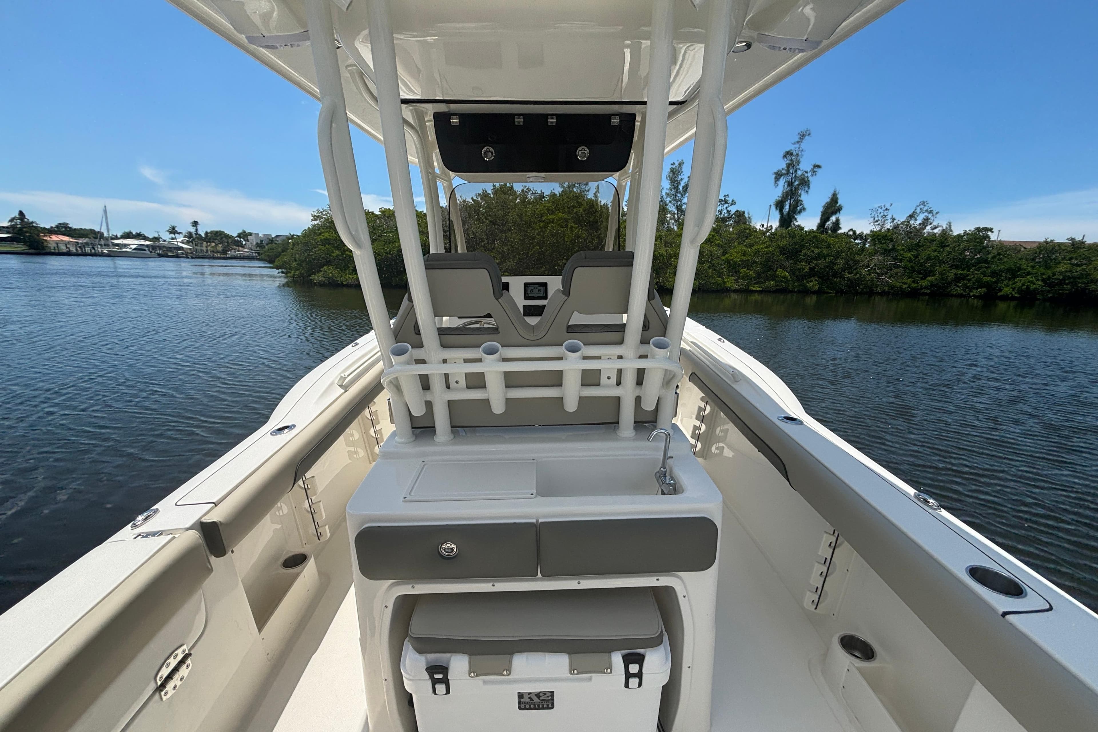 2026 Key West 260 CC boat interior on calm water, featuring seating and storage.