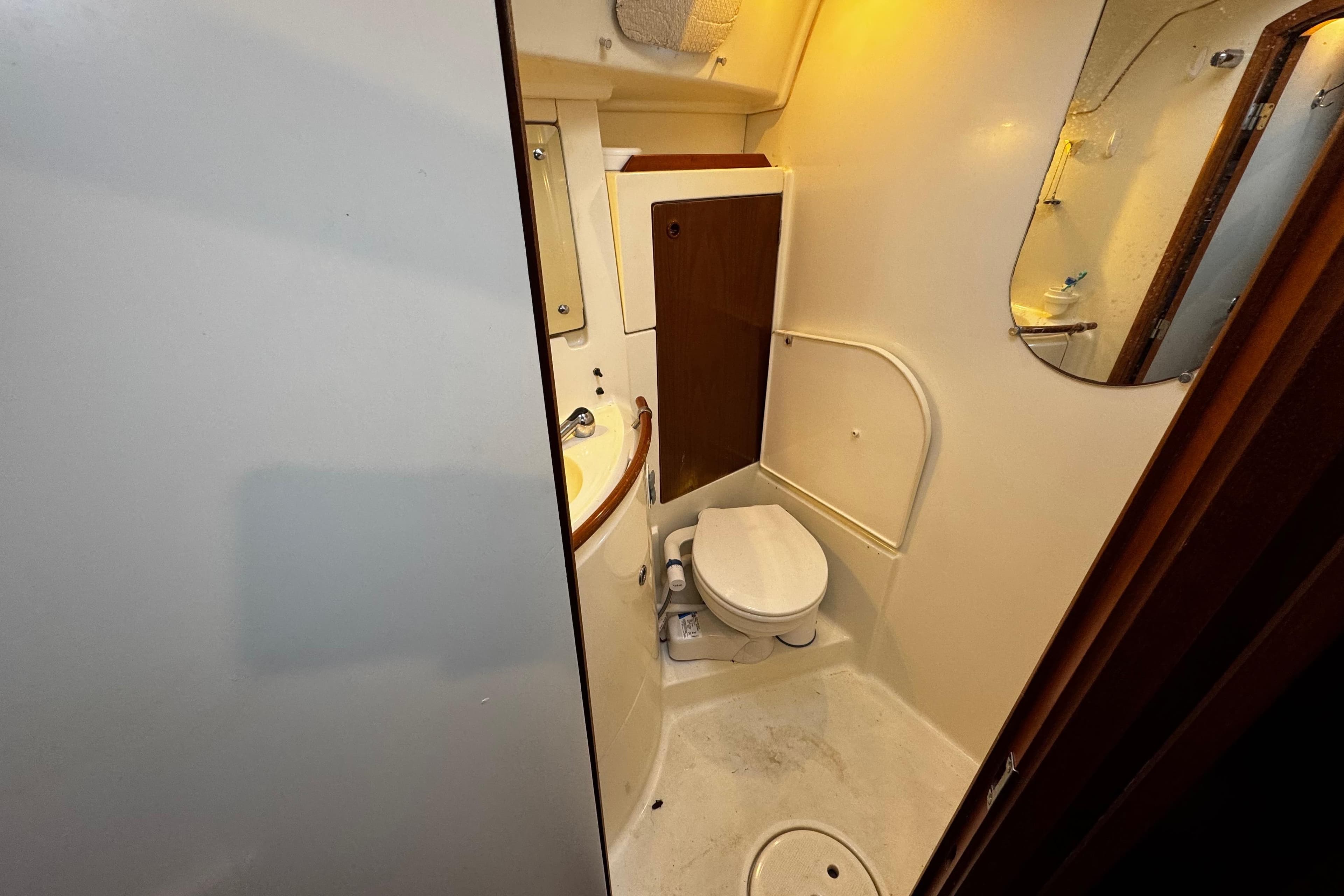 Bathroom interior of 1999 Beneteau Oceanis Clipper 461 yacht, featuring toilet and sink.