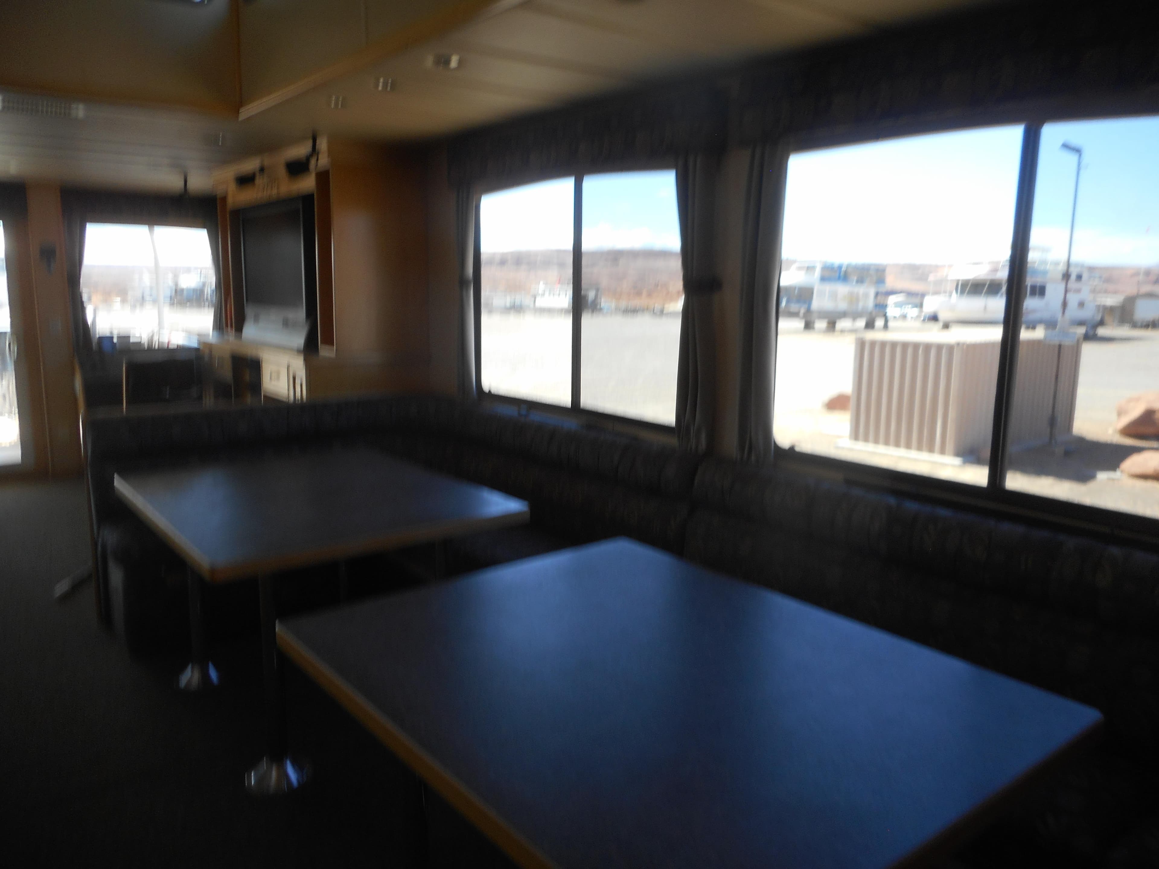 Interior of 2005 Twin Anchors Caspian share #9 houseboat with dining area and large windows.