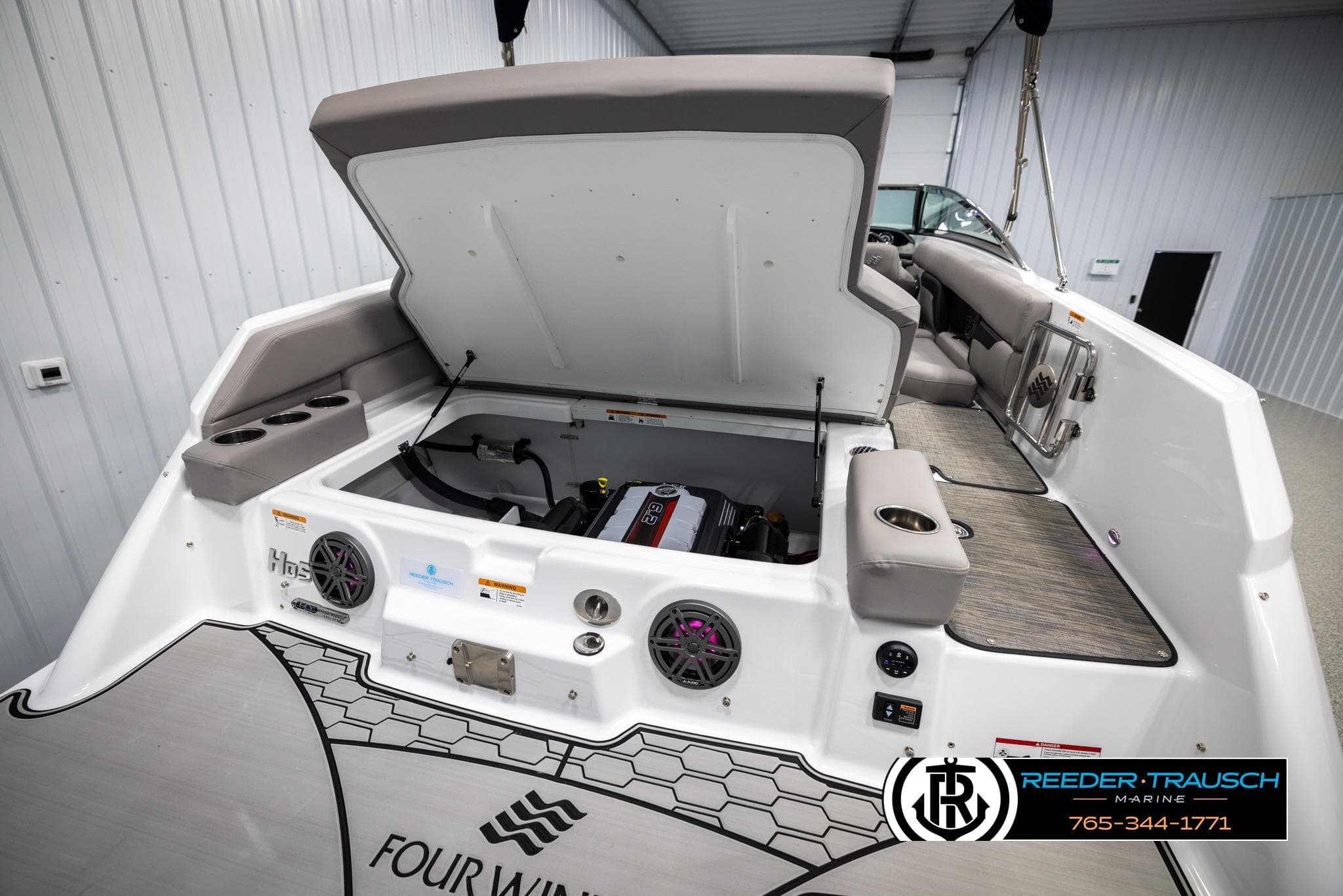 2025 Four Winns HD5 boat engine compartment with open hatch, showcasing interior features and design.