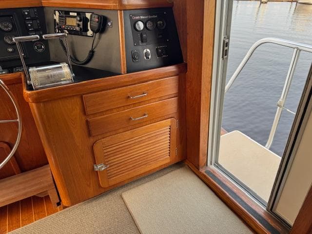 Interior of 1998 Cherubini 50 Independence yacht with wooden cabinetry and control panel.